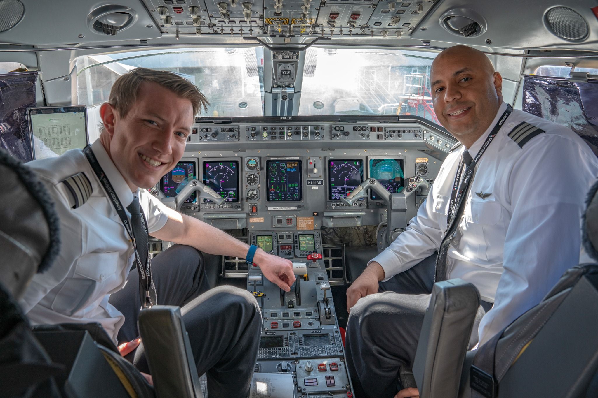 Two Piedmont Airlines pilots in a cockpit.
