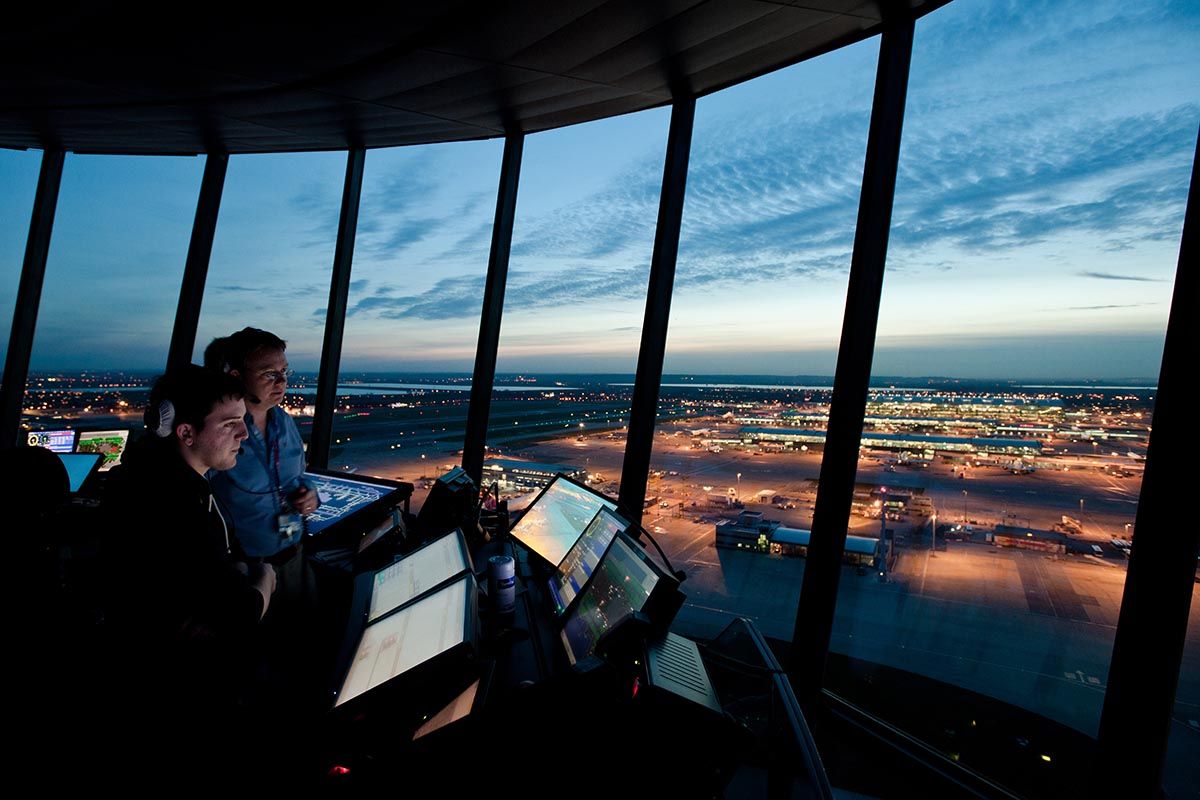 Air traffic controllers working in the tower at London Heathrow Airport.