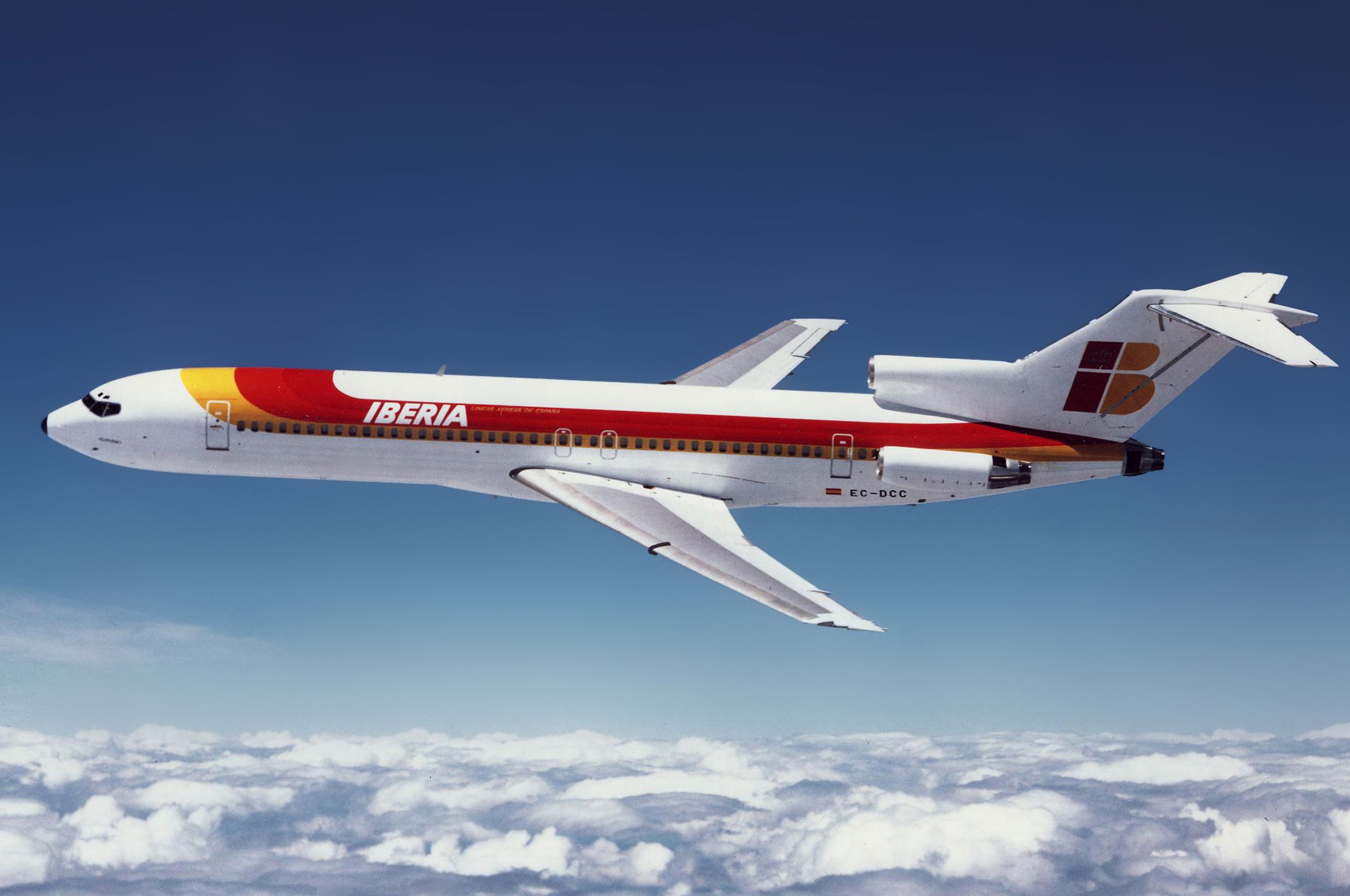 An Iberia Boeing 727 Flying above the clouds.