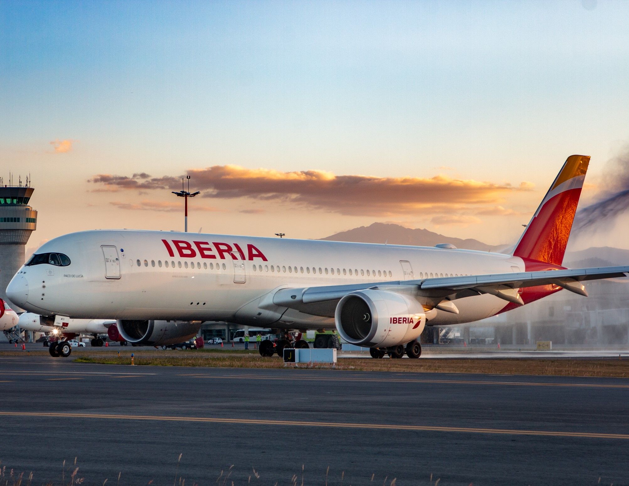 Iberia Airbus A350-900 on the tarmac after being sprayed with water.
