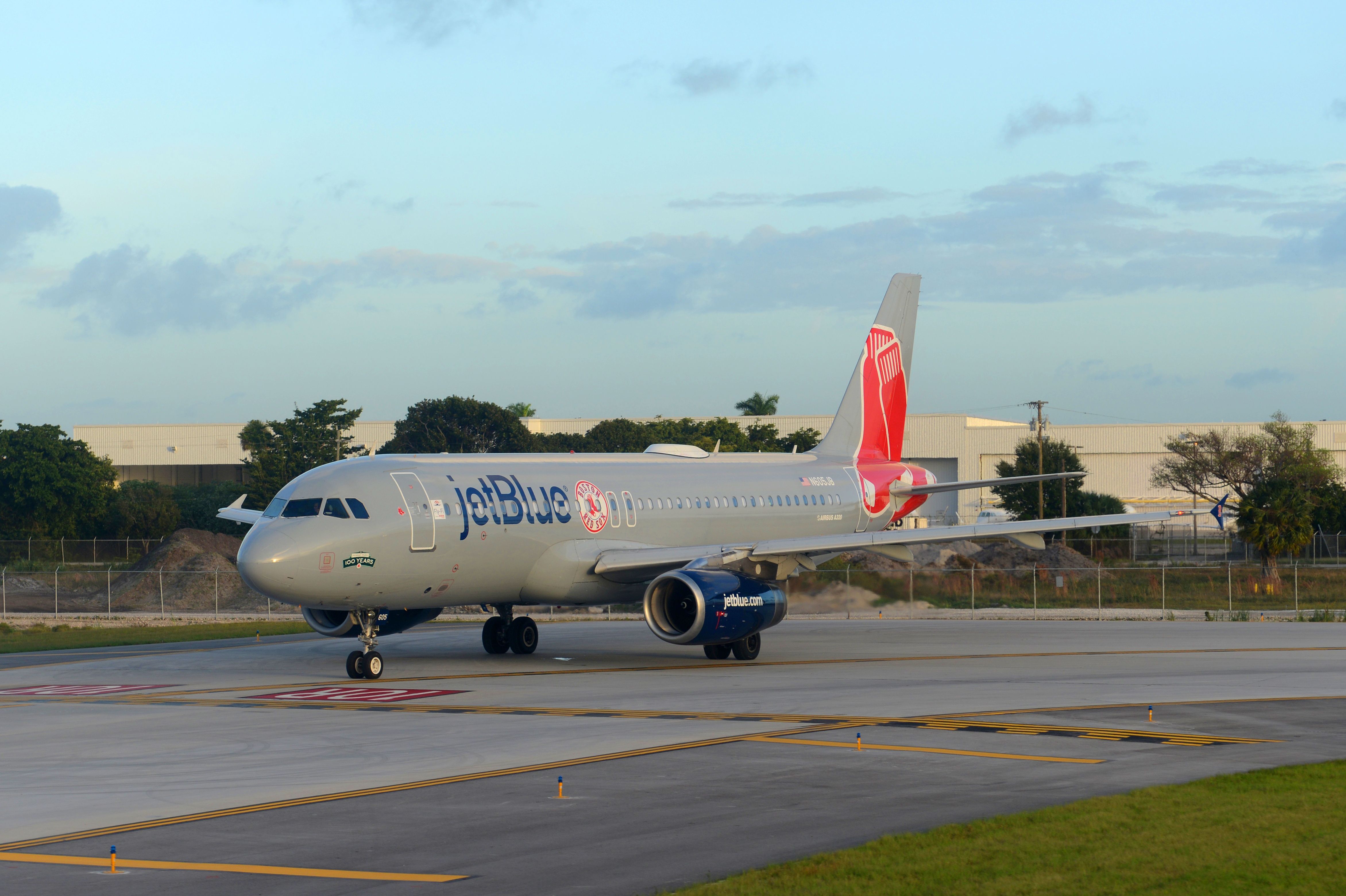 A JetBlue Airbus A320 in Red Sox Livery on an airport apron.