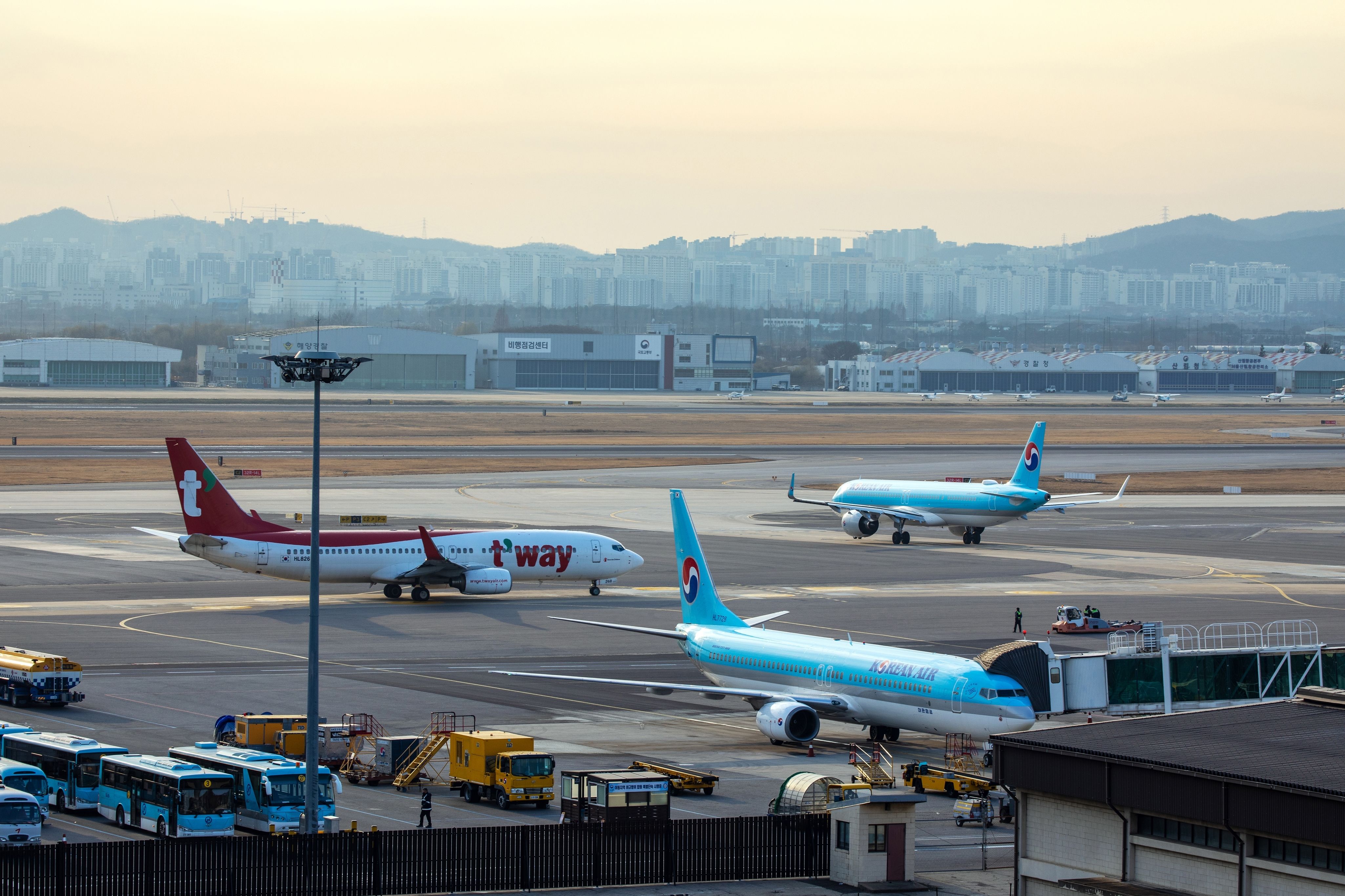 Korean Air and T'way Boeing 737-800 aircraft on the apron at Seoul Gimpo International Airport.