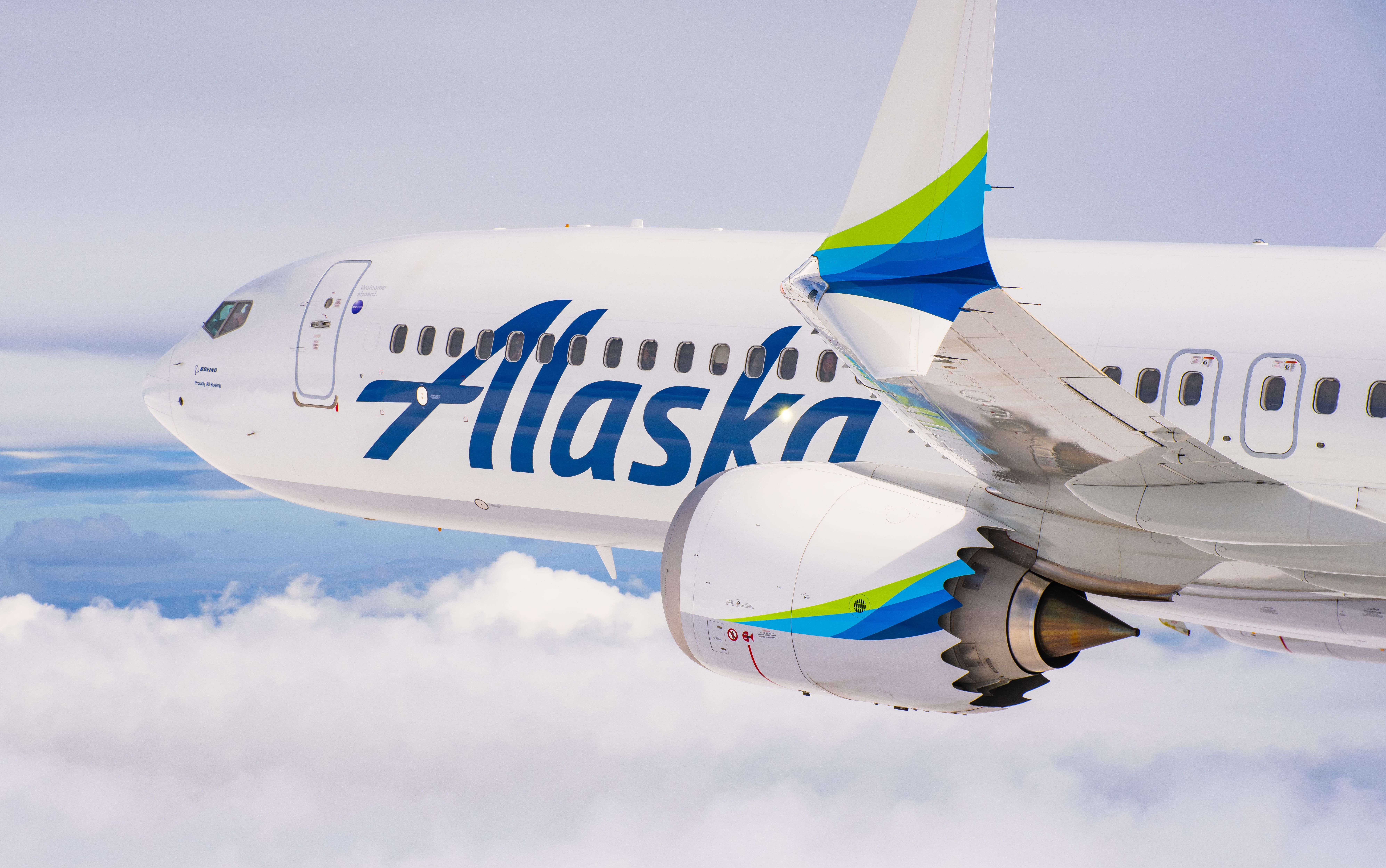 A closeup of an Alaska Airlines Boeing 737 MAX 9's engines and split winglets.