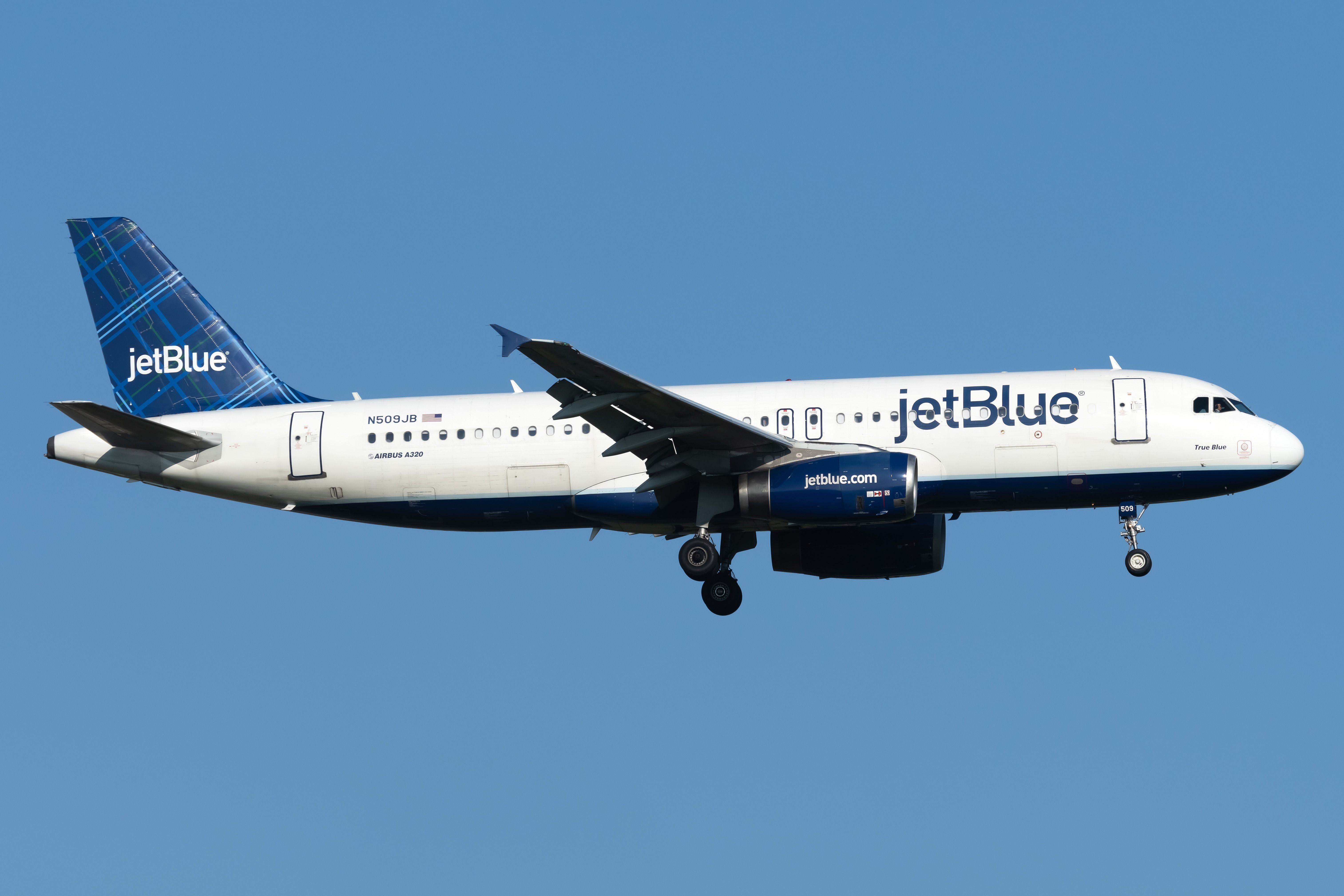 A JetBlue Airways Airbus A320-232 flying in the sky.