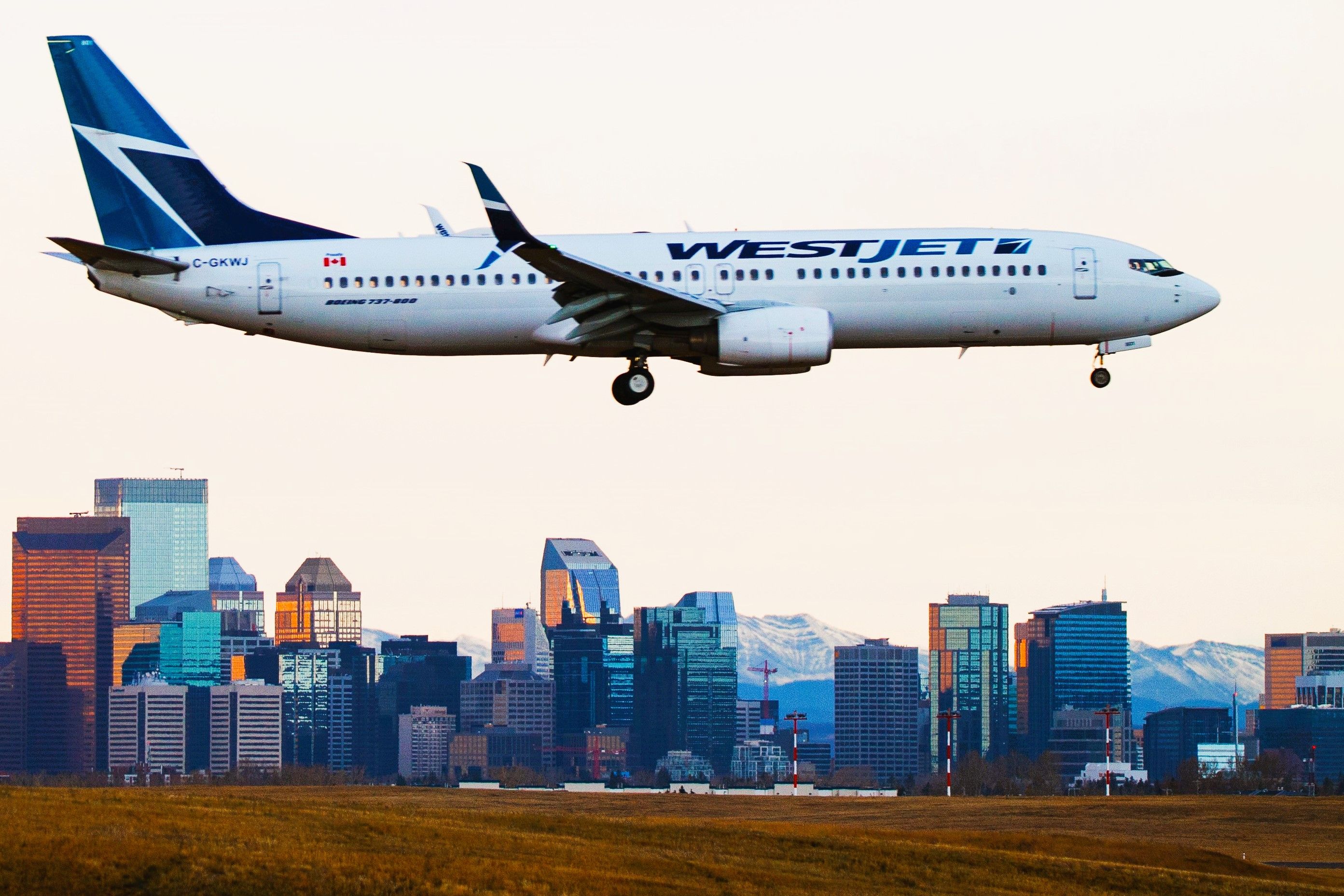 shutterstock_1055754497 - 4x6 - CALGARY, CANADA - OCTOBER 24, 2017: WestJet Airlines C-GKWJ Boeing 737-800 landing over the city skyline at Calgary International Airport.