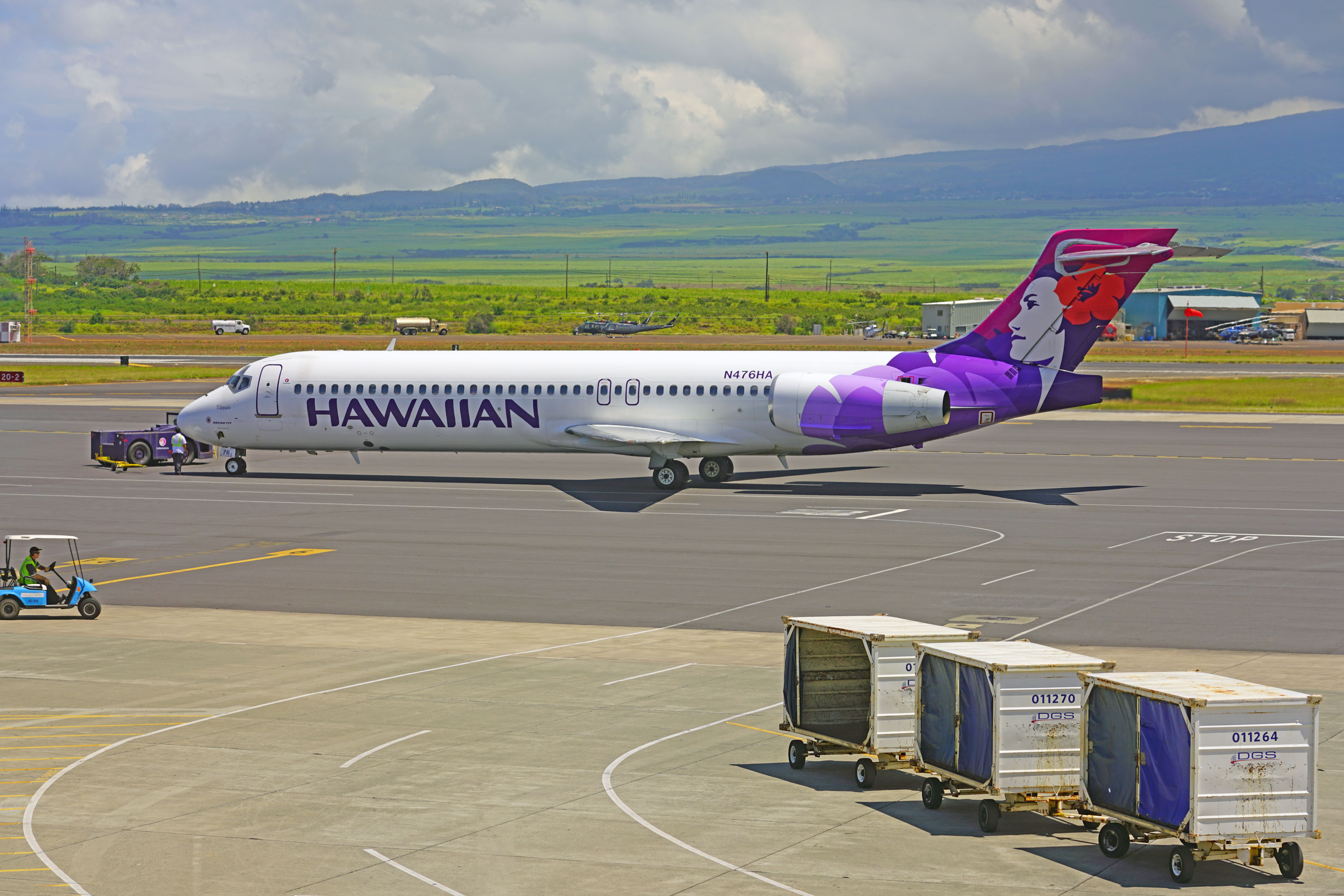 A Hawaiian Airlines Boeing 717 parked on an airport apron.