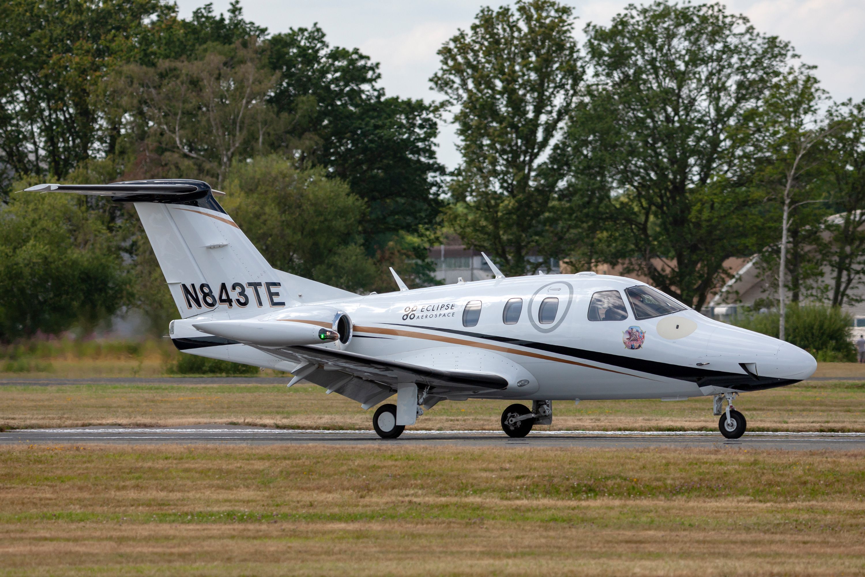 An Eclipse 500 business jet on an airport apron.