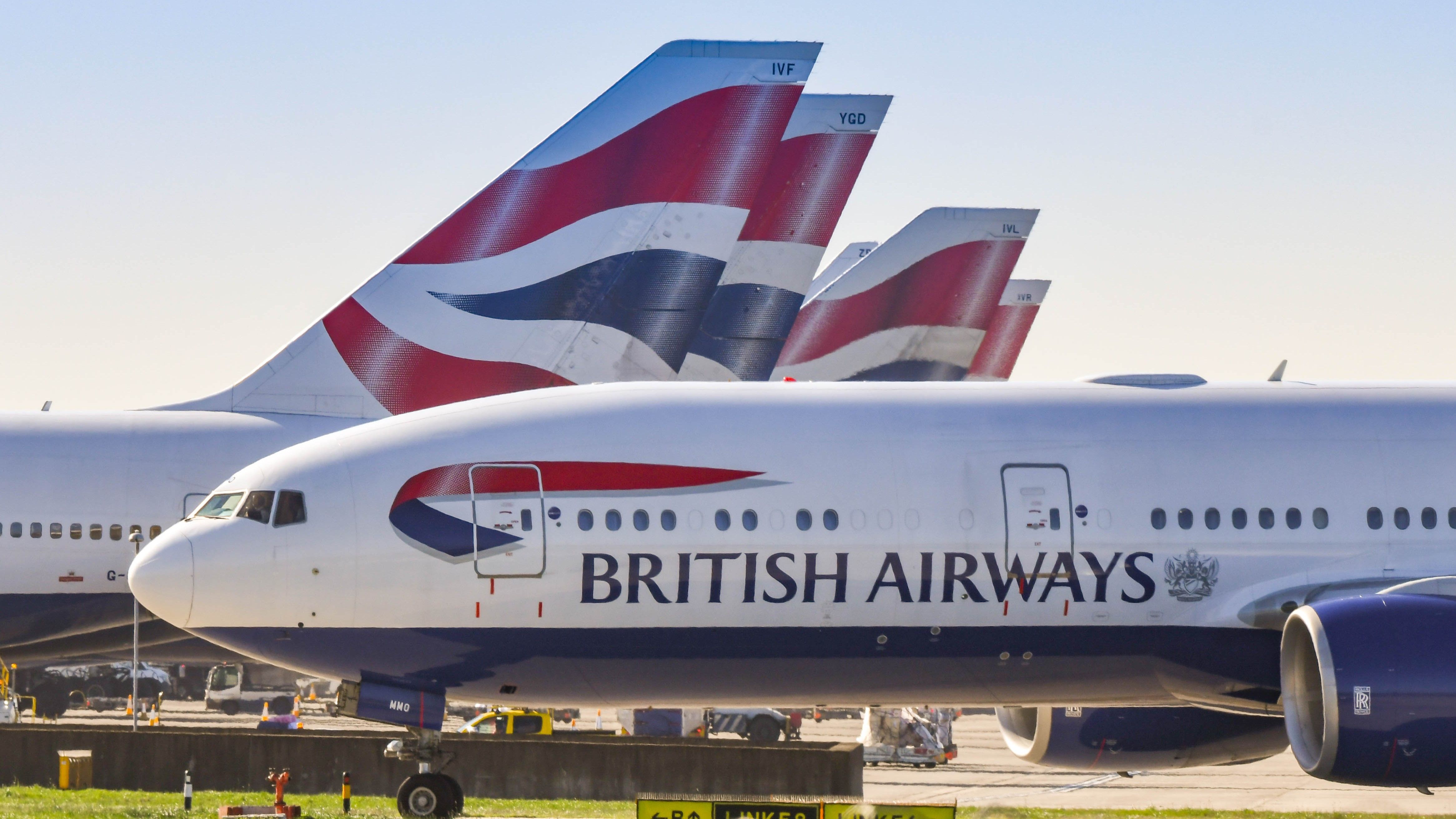 Several British Airways aircraft on an airport apron.