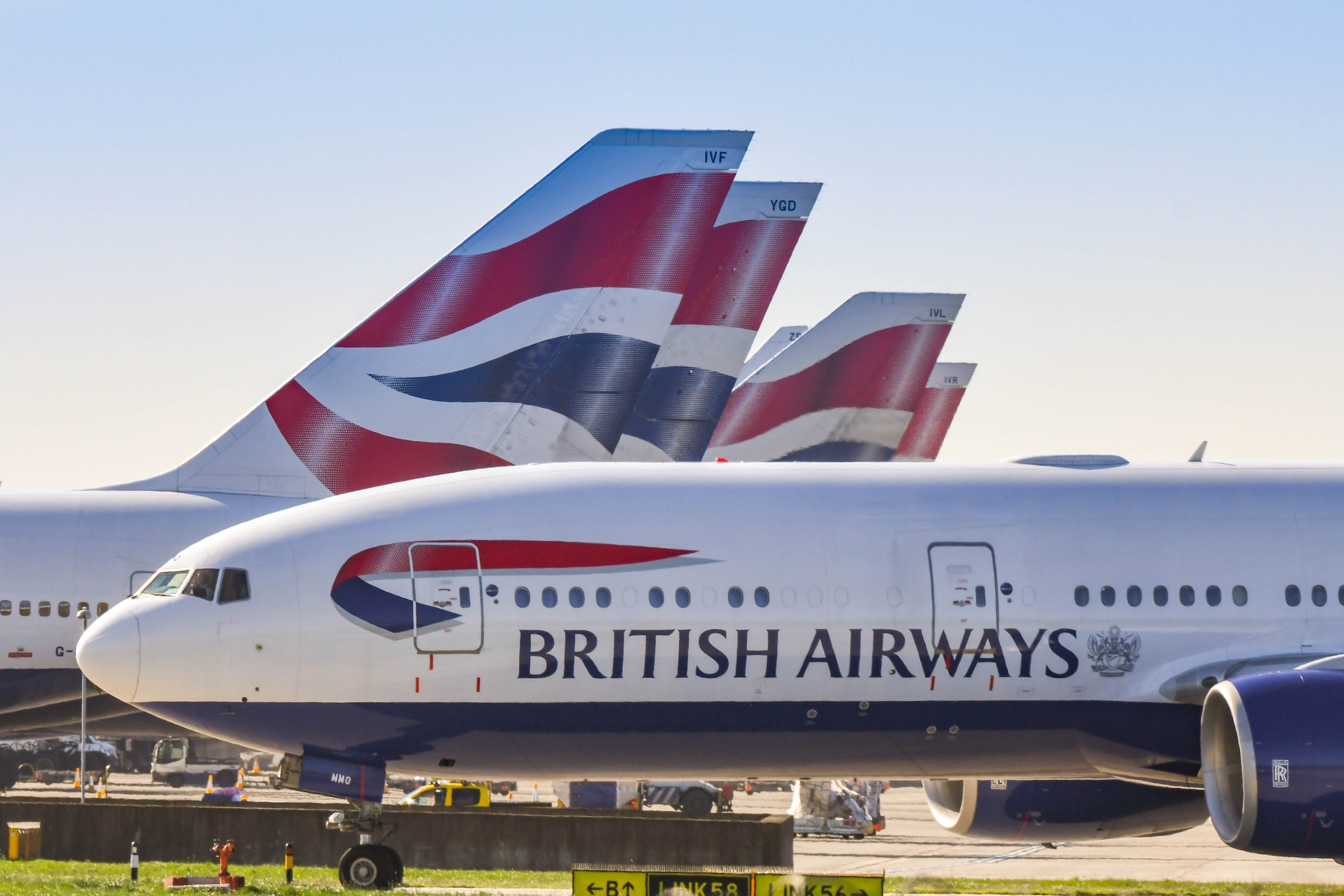 A Closeup of a British Airways Boeing 777 In front of several parked British Airways aircraft.