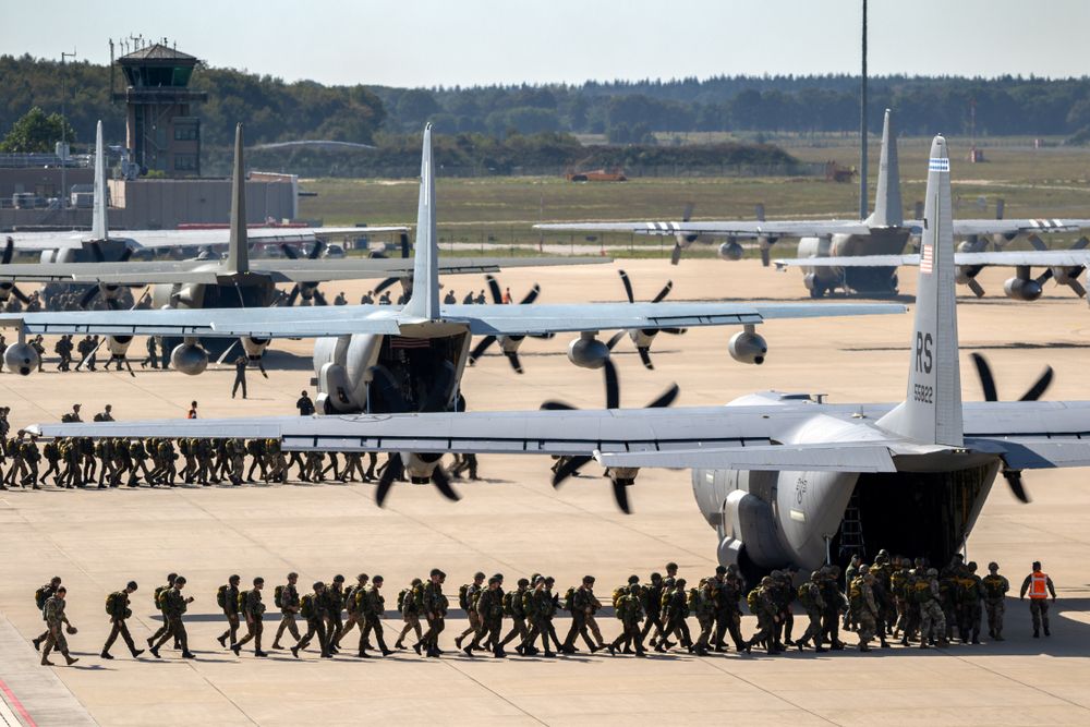 Paratroopers boarding US Air Force C-130 Hercules aircraft.