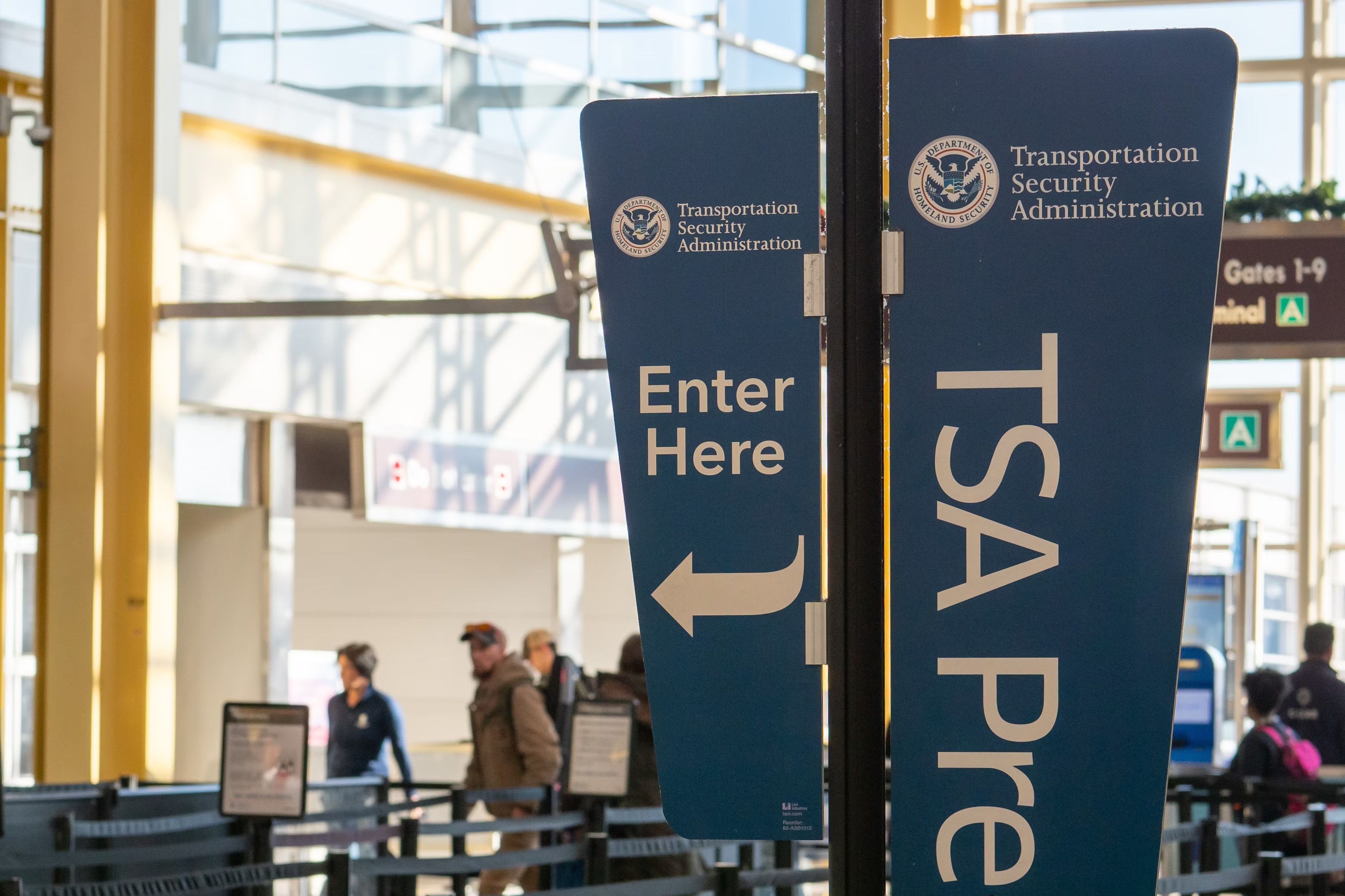 A TSA Precheck sign at an airport security checkpoint.