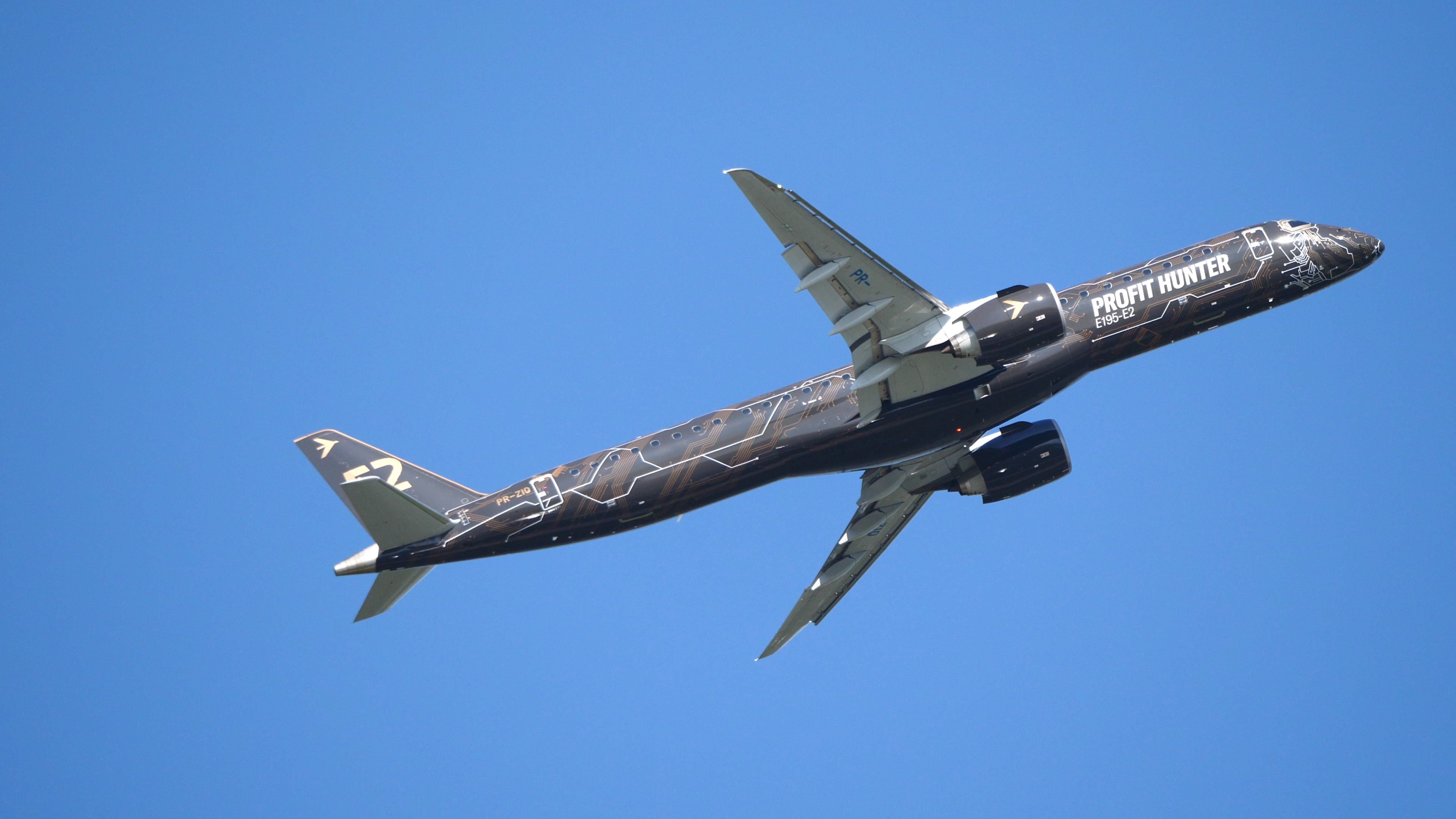 An Embraer E195-E2 flying in the sky.