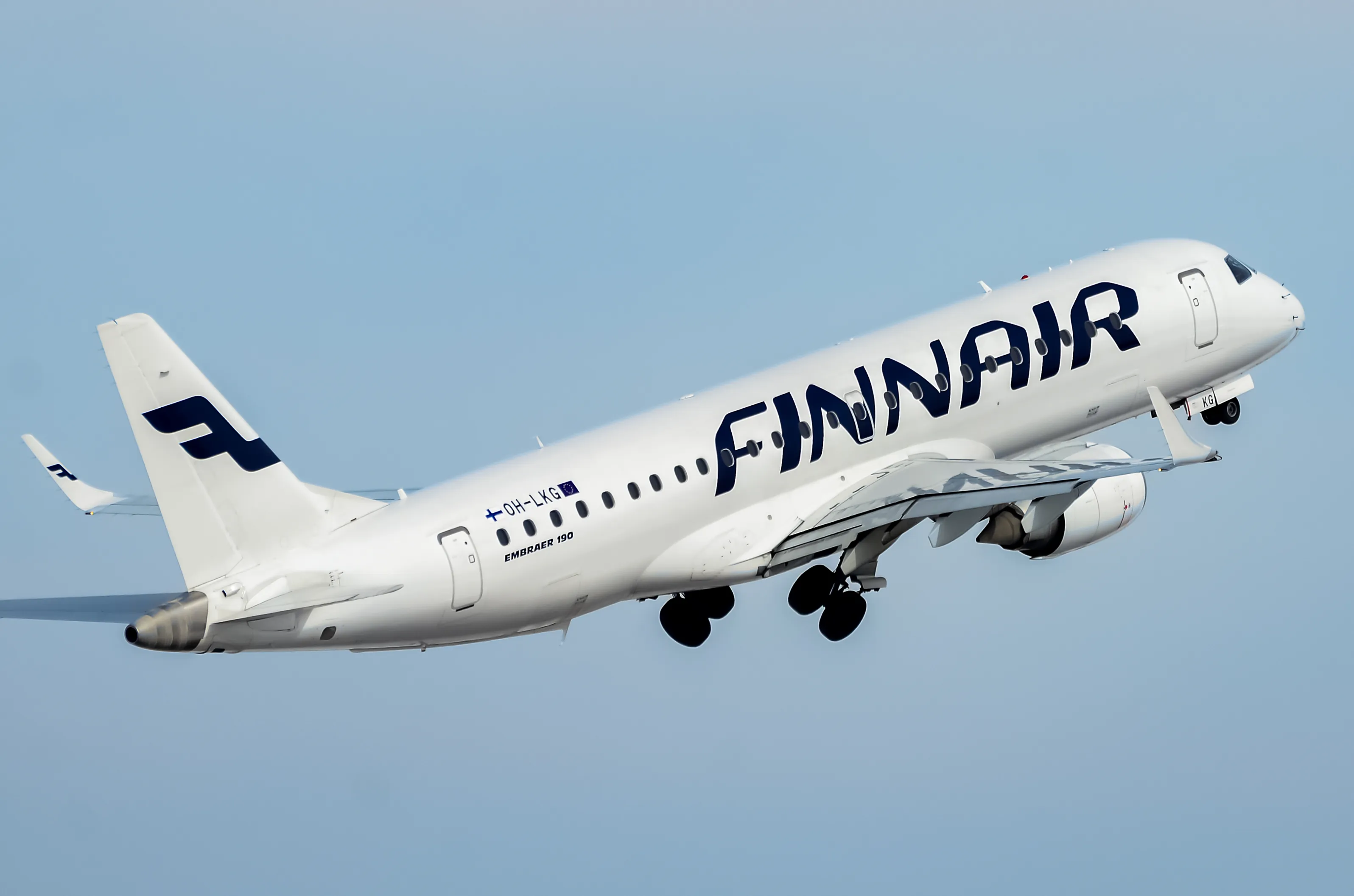 Finnair Embraer E190 flying in the sky.