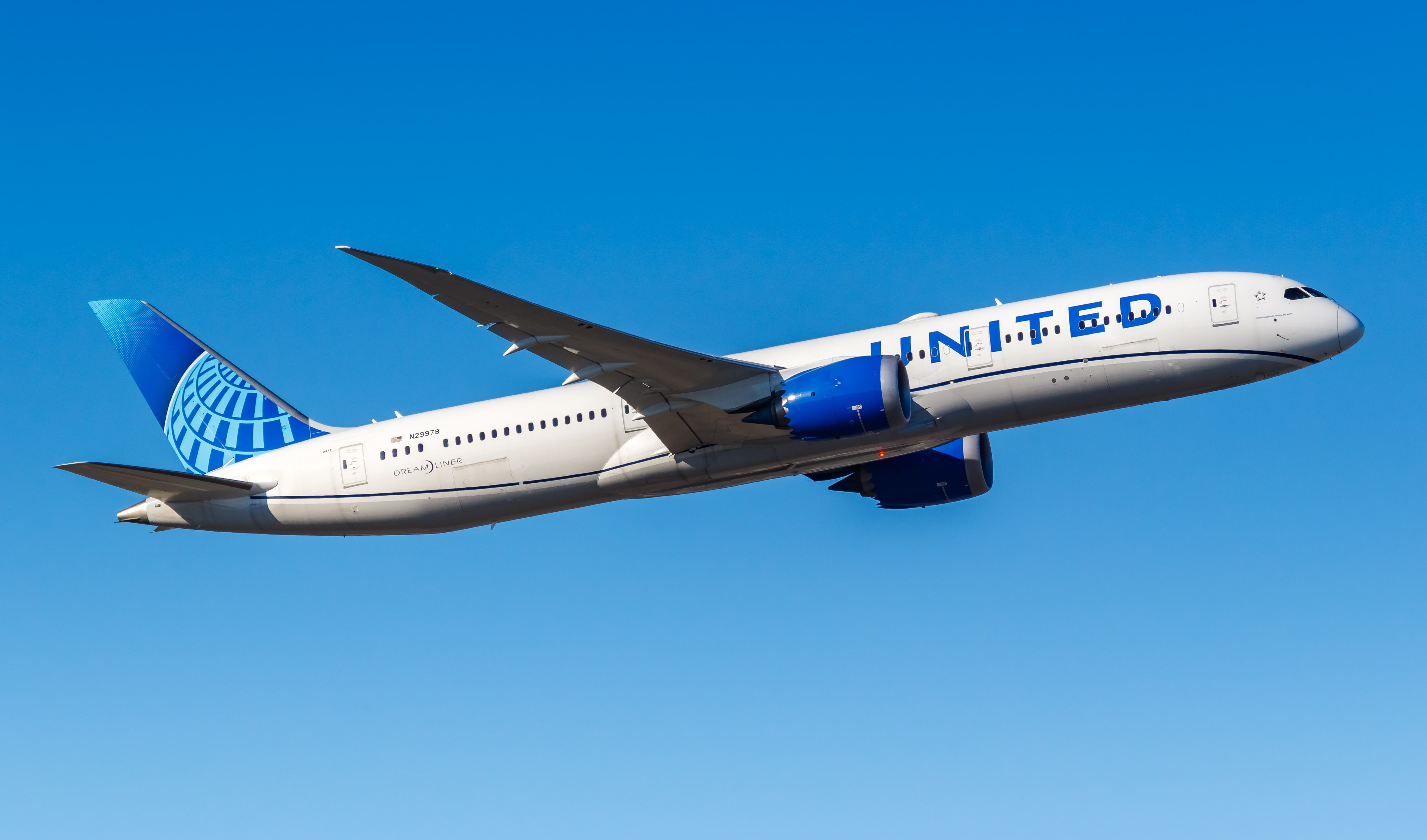A United Airlines Boeing 787-9 flying in the sky.