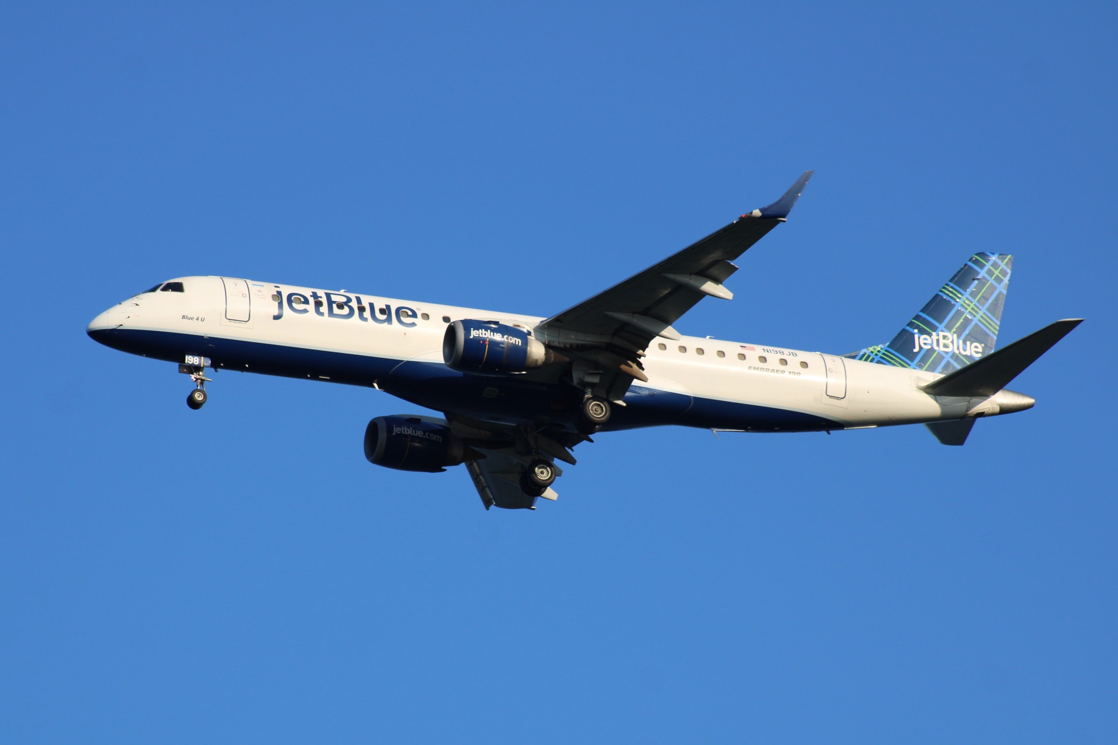 A JetBlue Airways Embraer E190 Flying In The Sky.