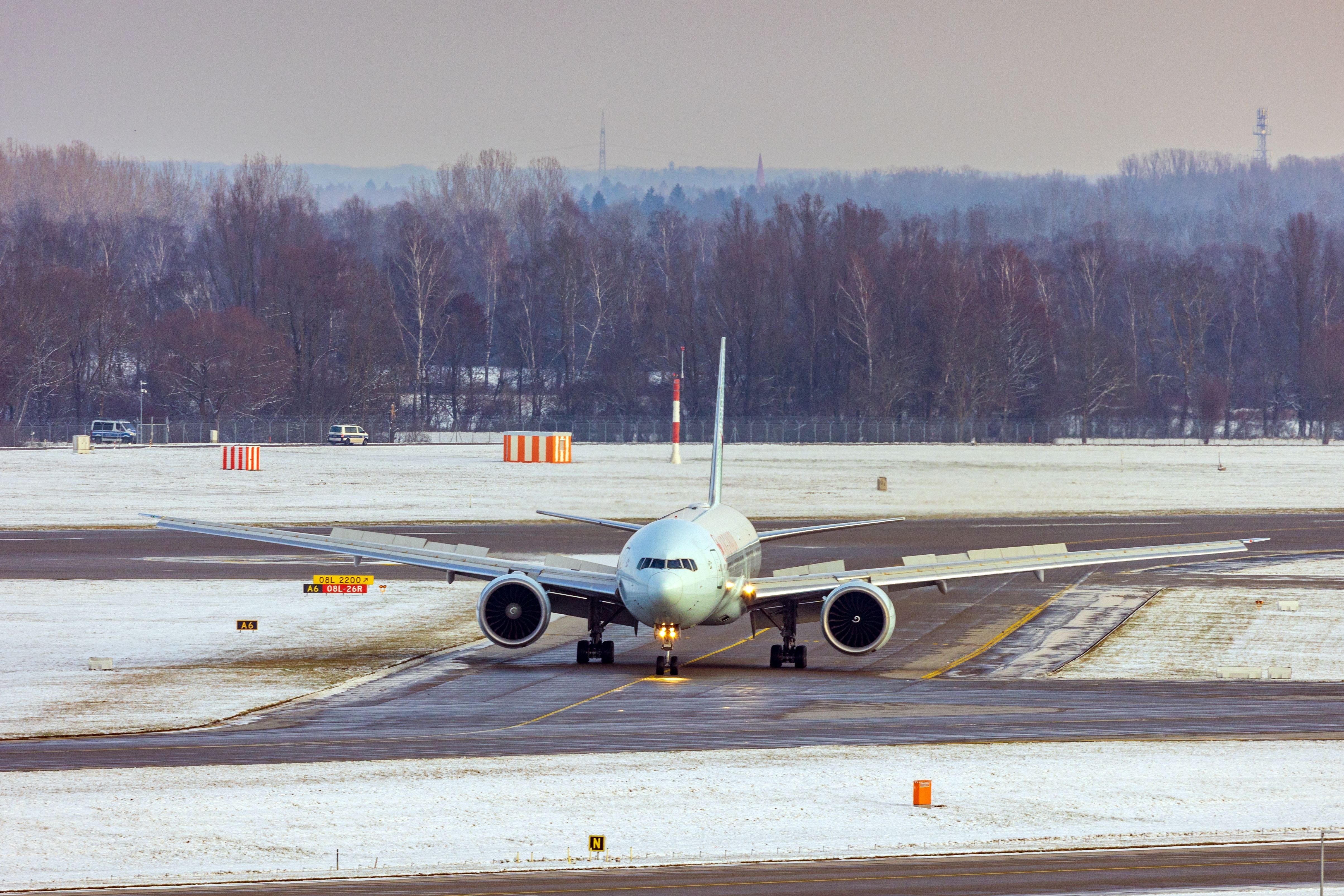 ommercial airplane at Munich airport in Germany, during a cold winter day with snow