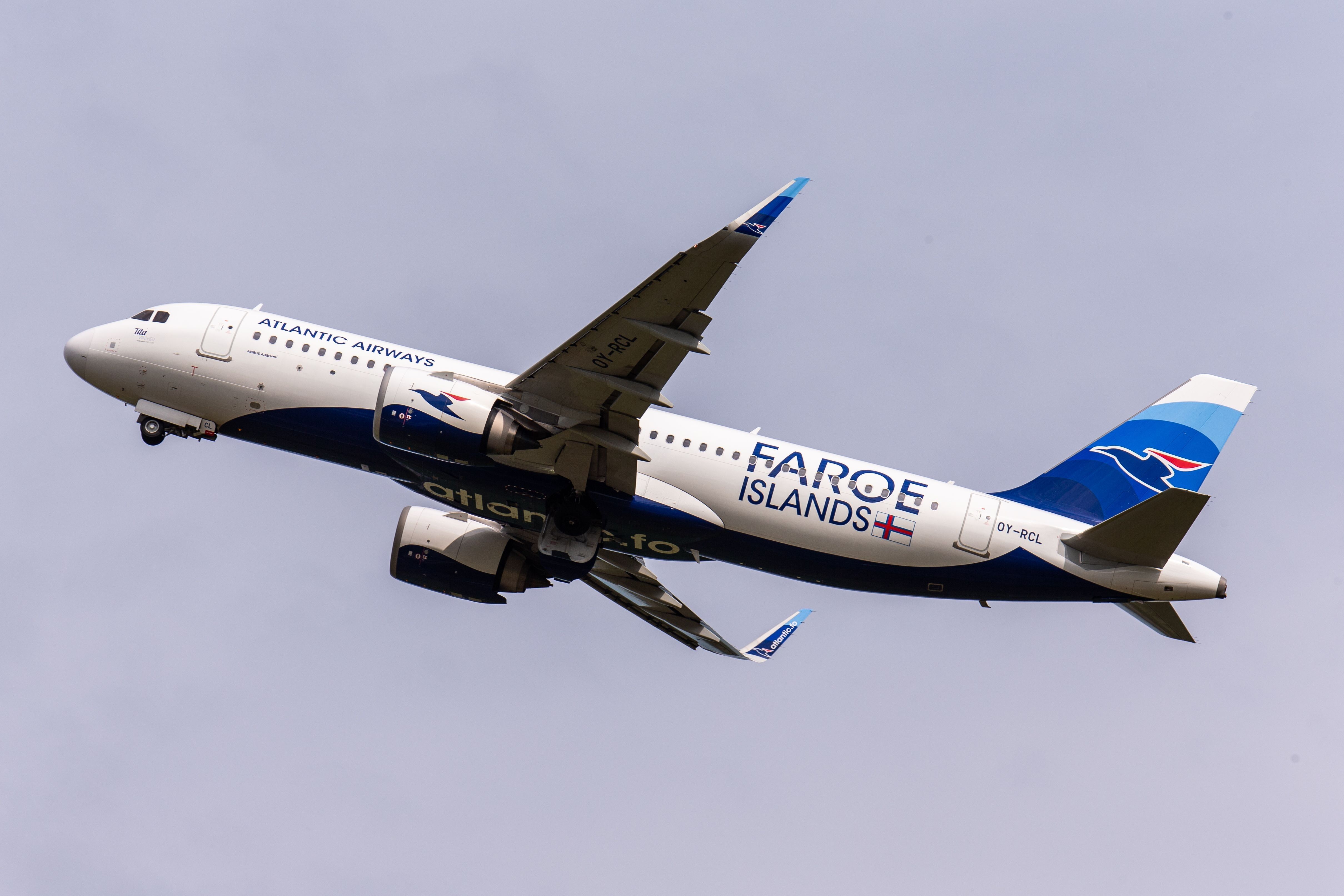 A closeup of an Atlantic Airways Airbus A320-200 flying in the sky.