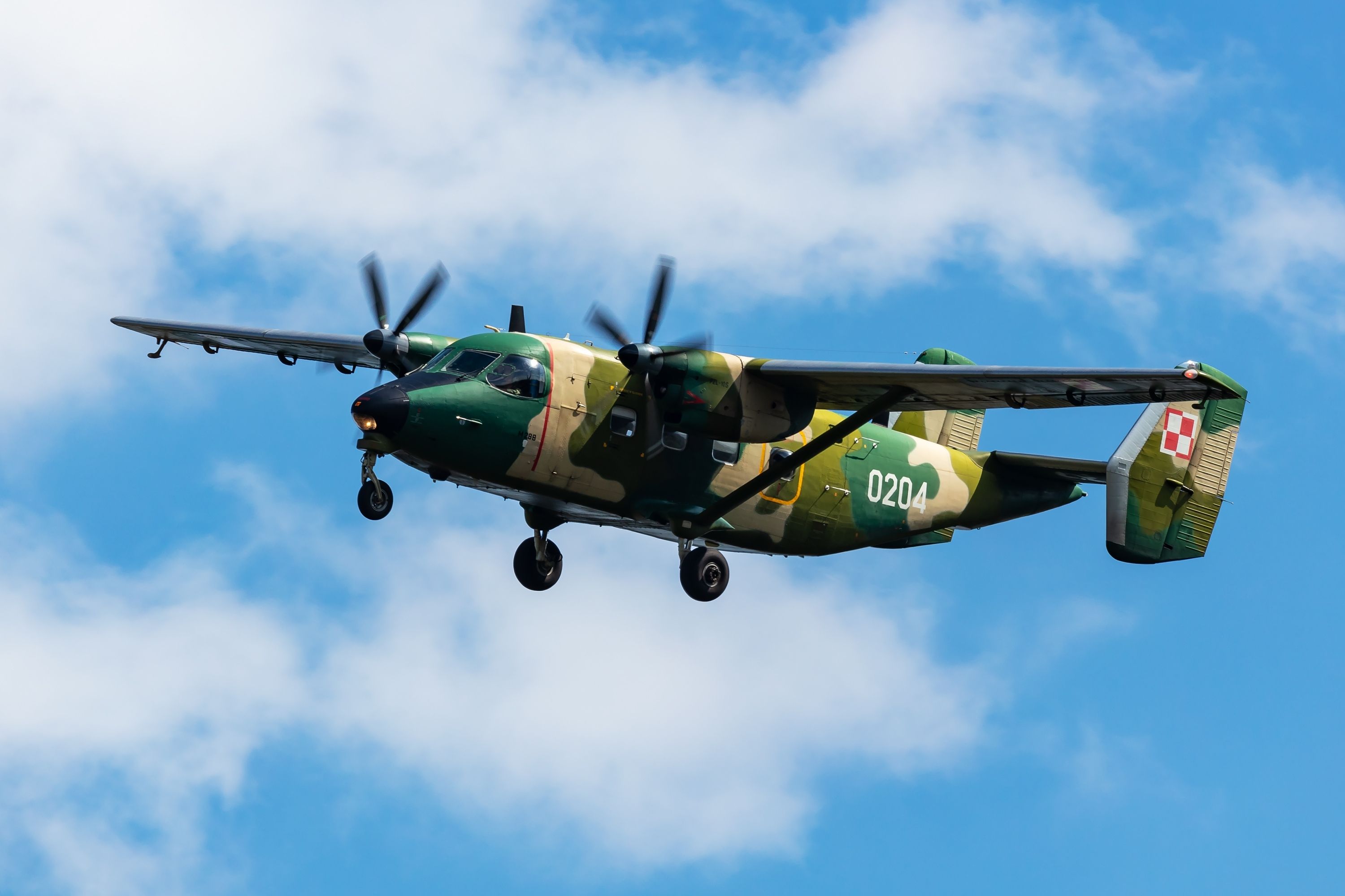 A Polish Air Force PZL M28 Bryza transport plane flying in the sky.
