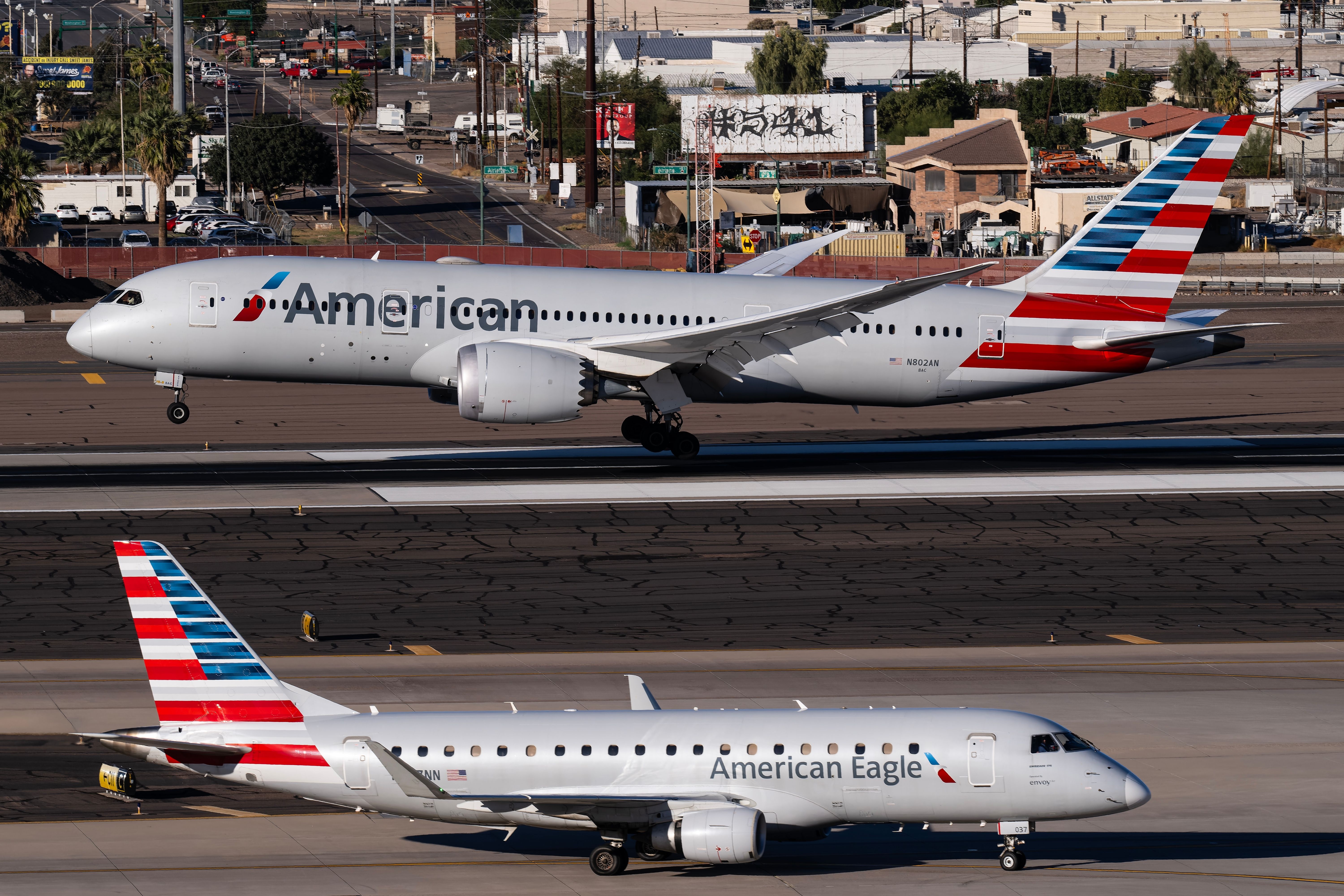 Two American Airlines aircraft on the apron at Phoenix Sky Harbor Airport.