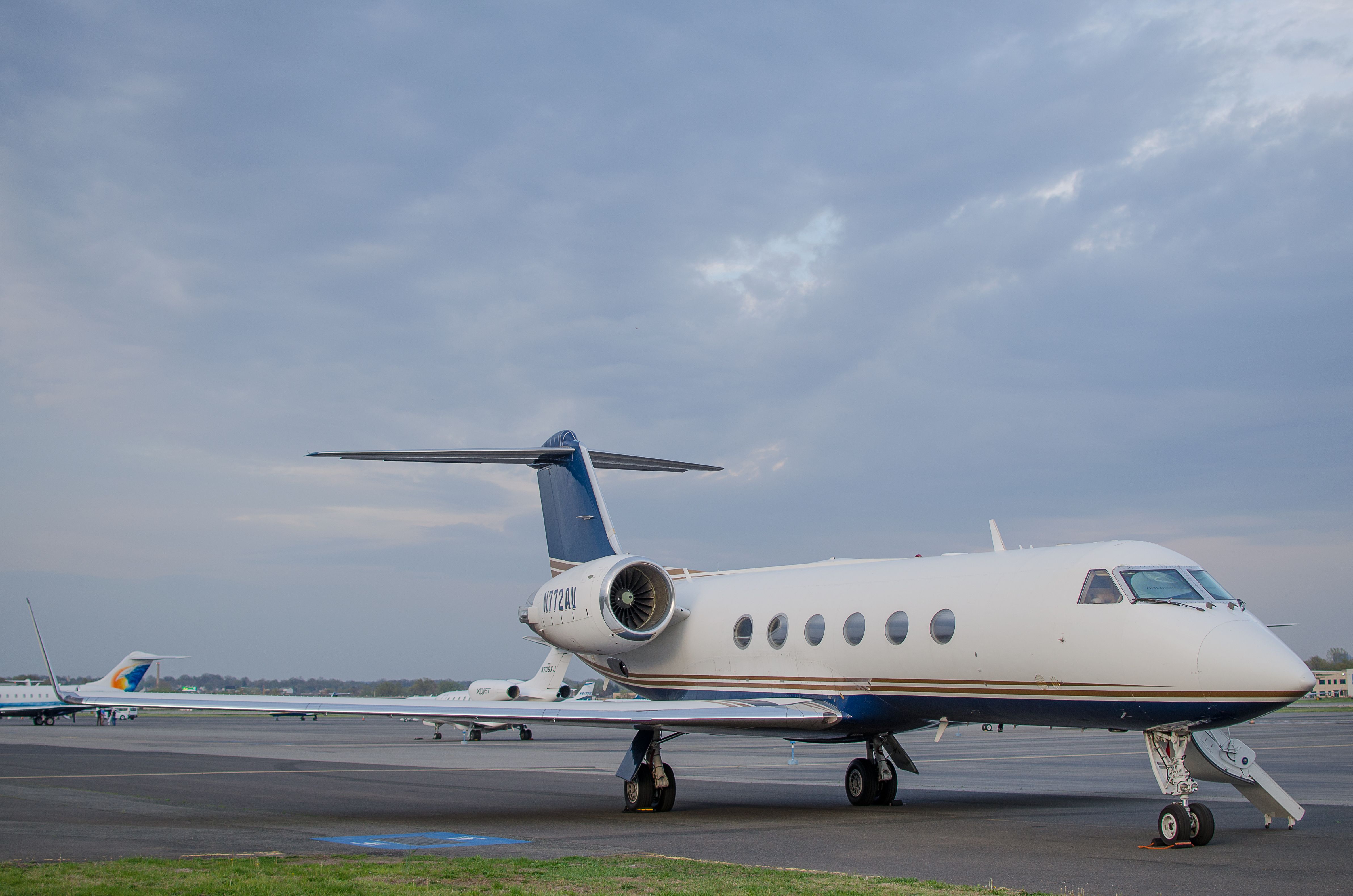 A business jet parked on an airport apron.