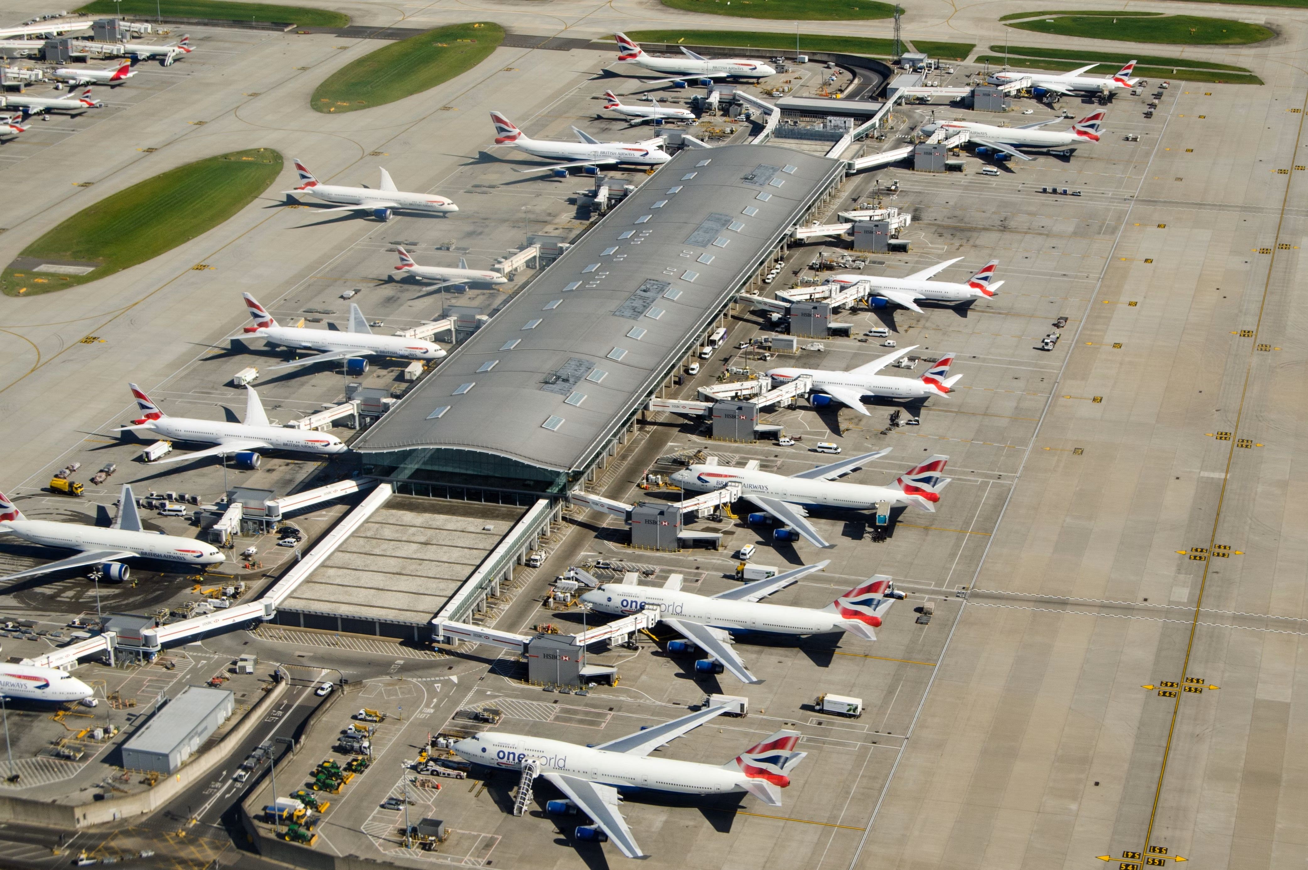 Several British Airways Aircraft parked at gates at London Heathrow Airport.