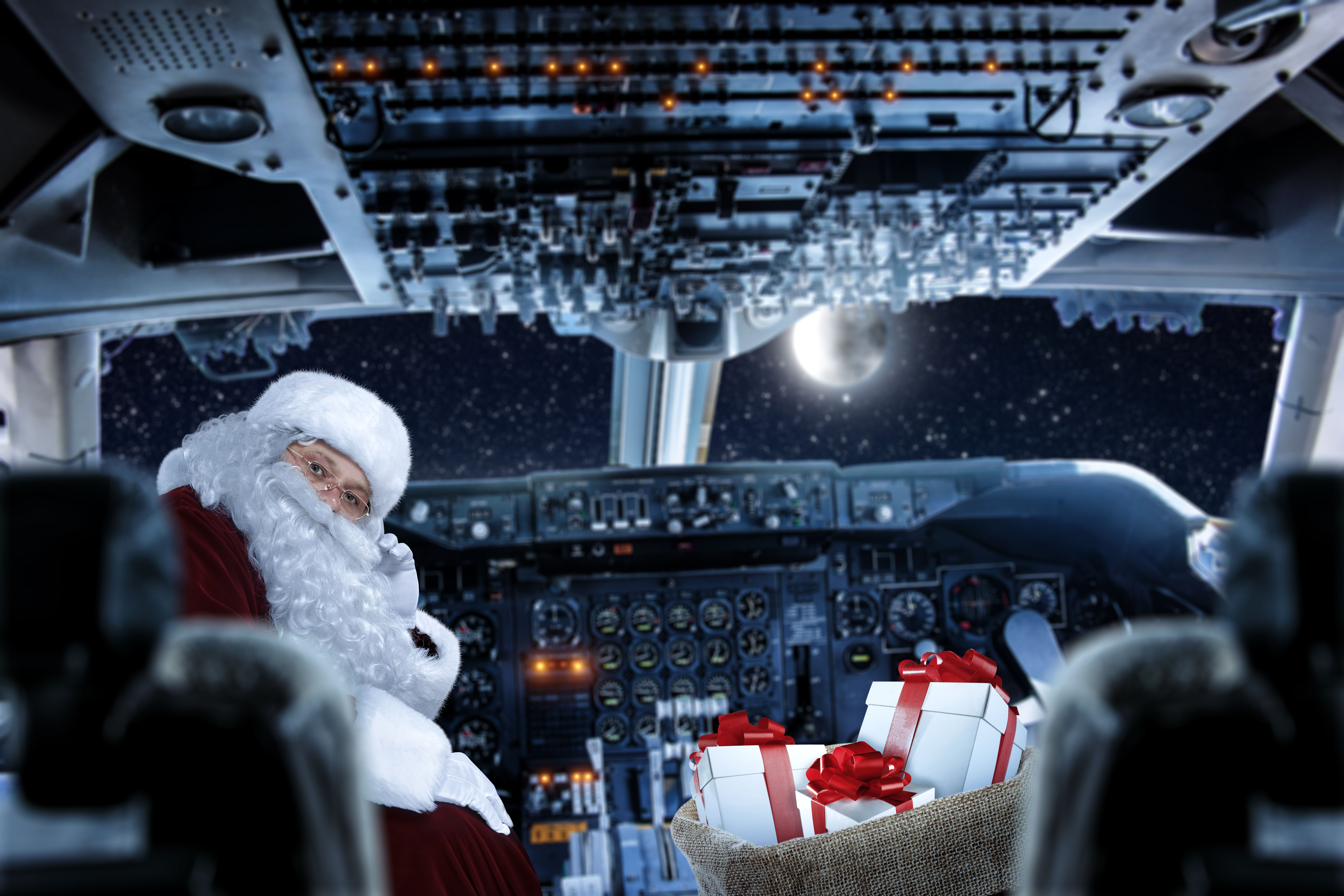 A photoshopped image of Santa in an aircraft cockpit with gifts.