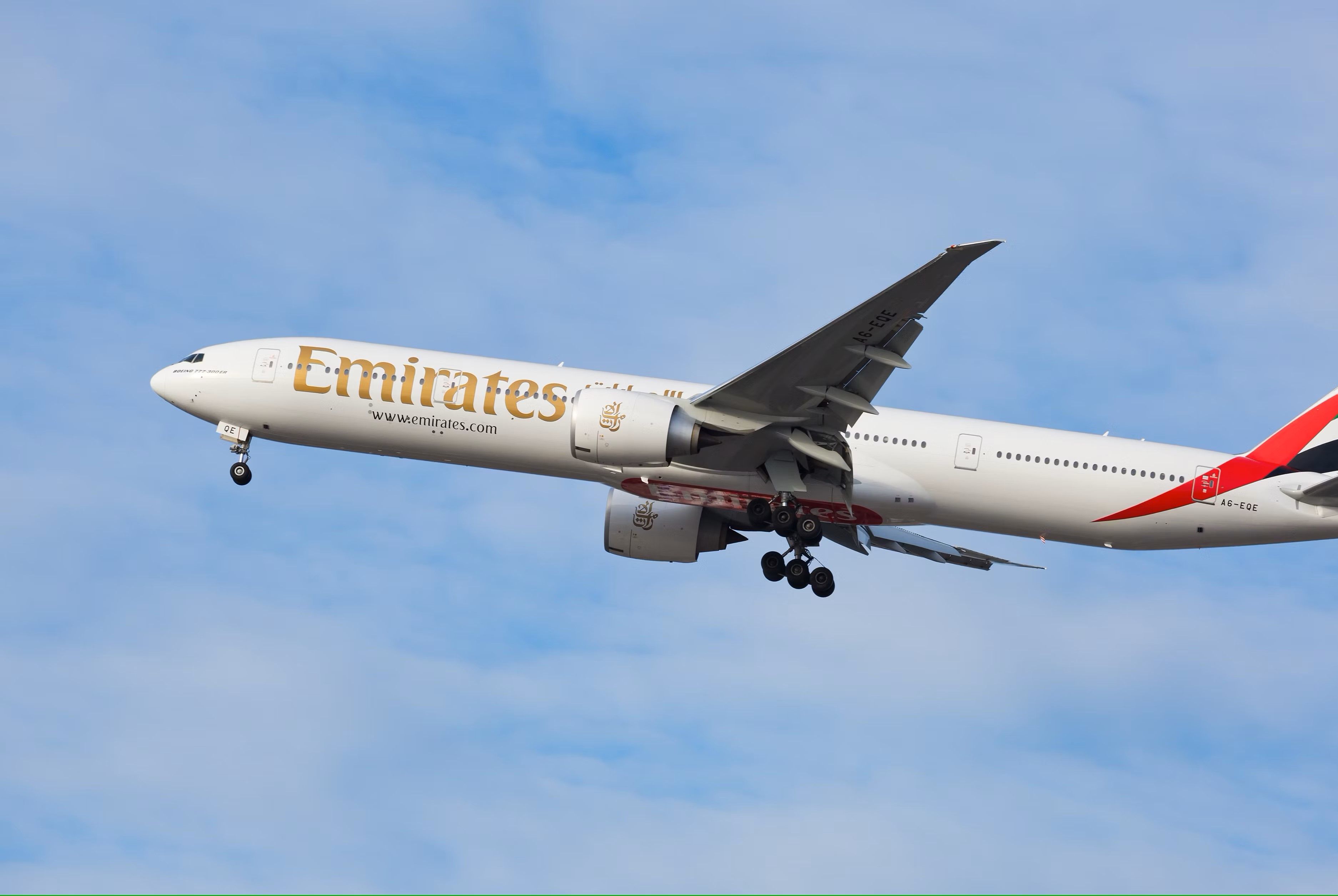 An Emirates Boeing 777 Flying in the sky.