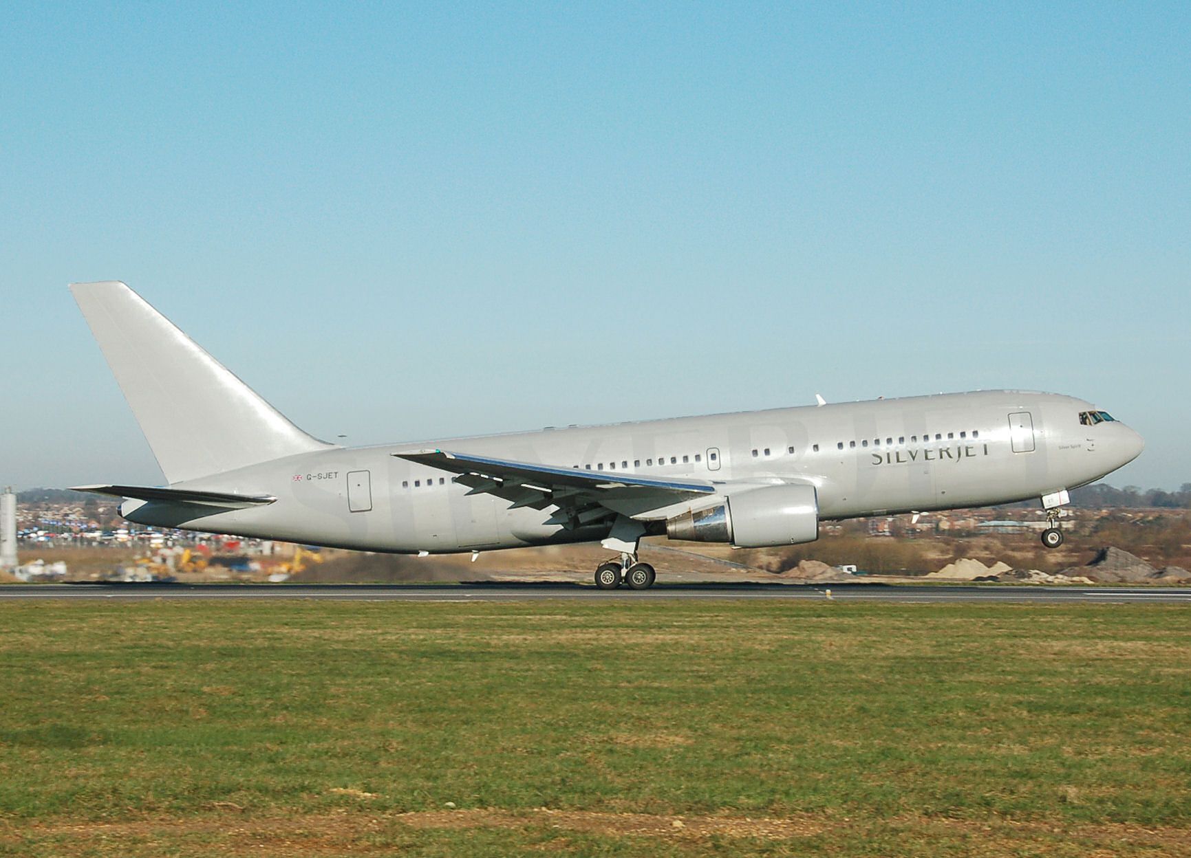 A silverjet boeing 767-200 about to take off.