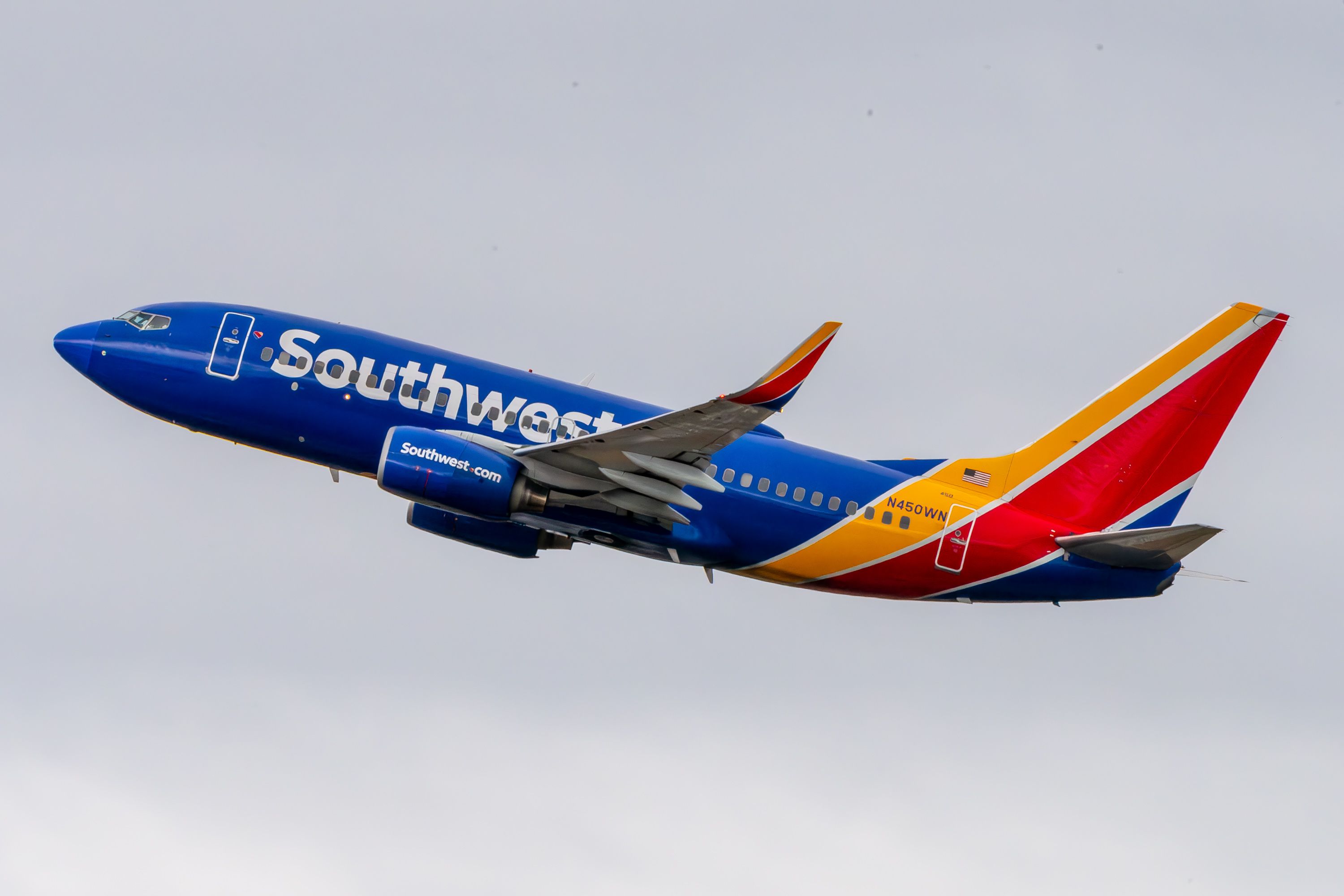 A Southwest Airlines 737-700 flying in the sky.