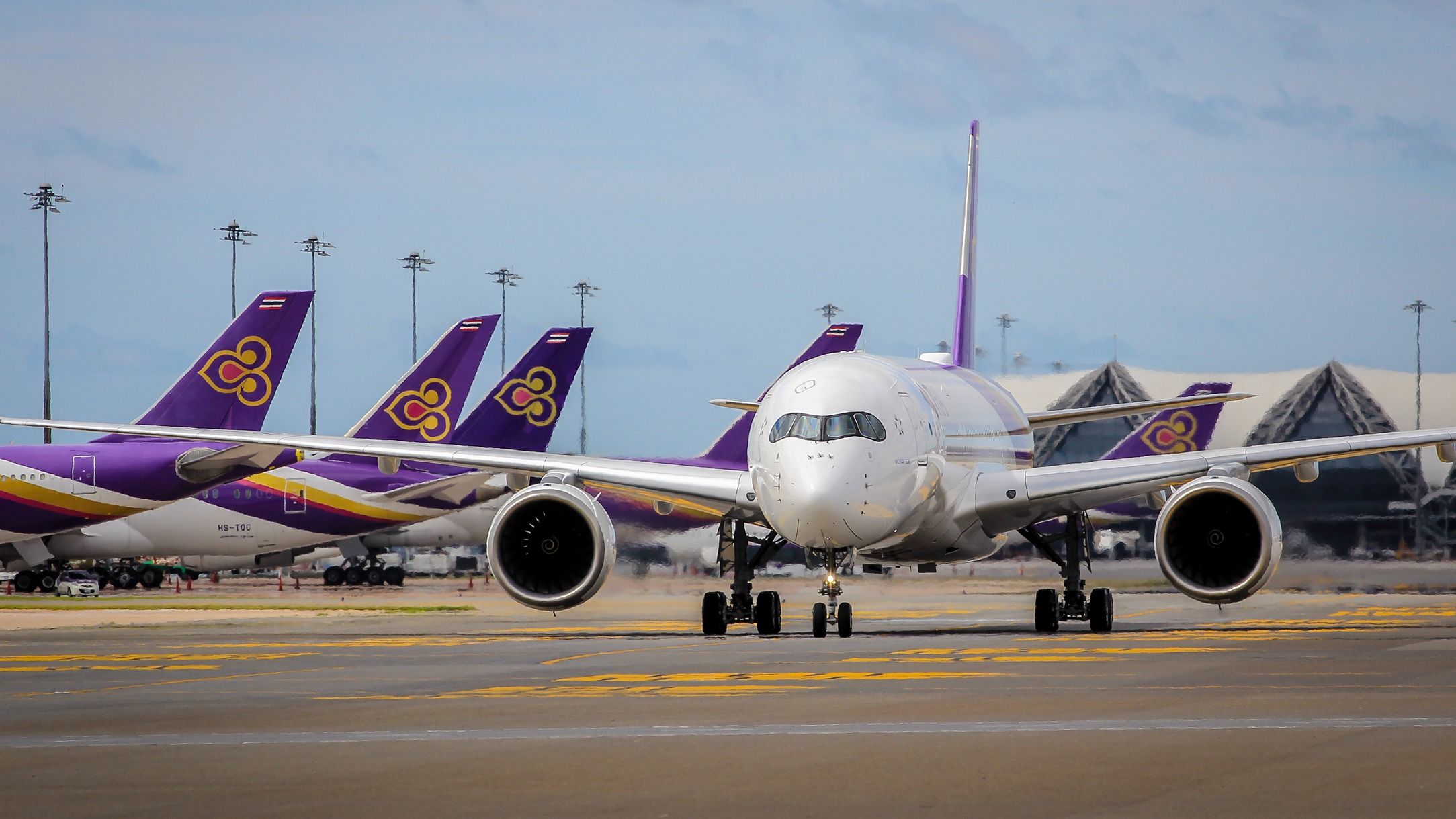 Thai Airways Airbus A350 with other Thai Airways aircraft in the background at BKK