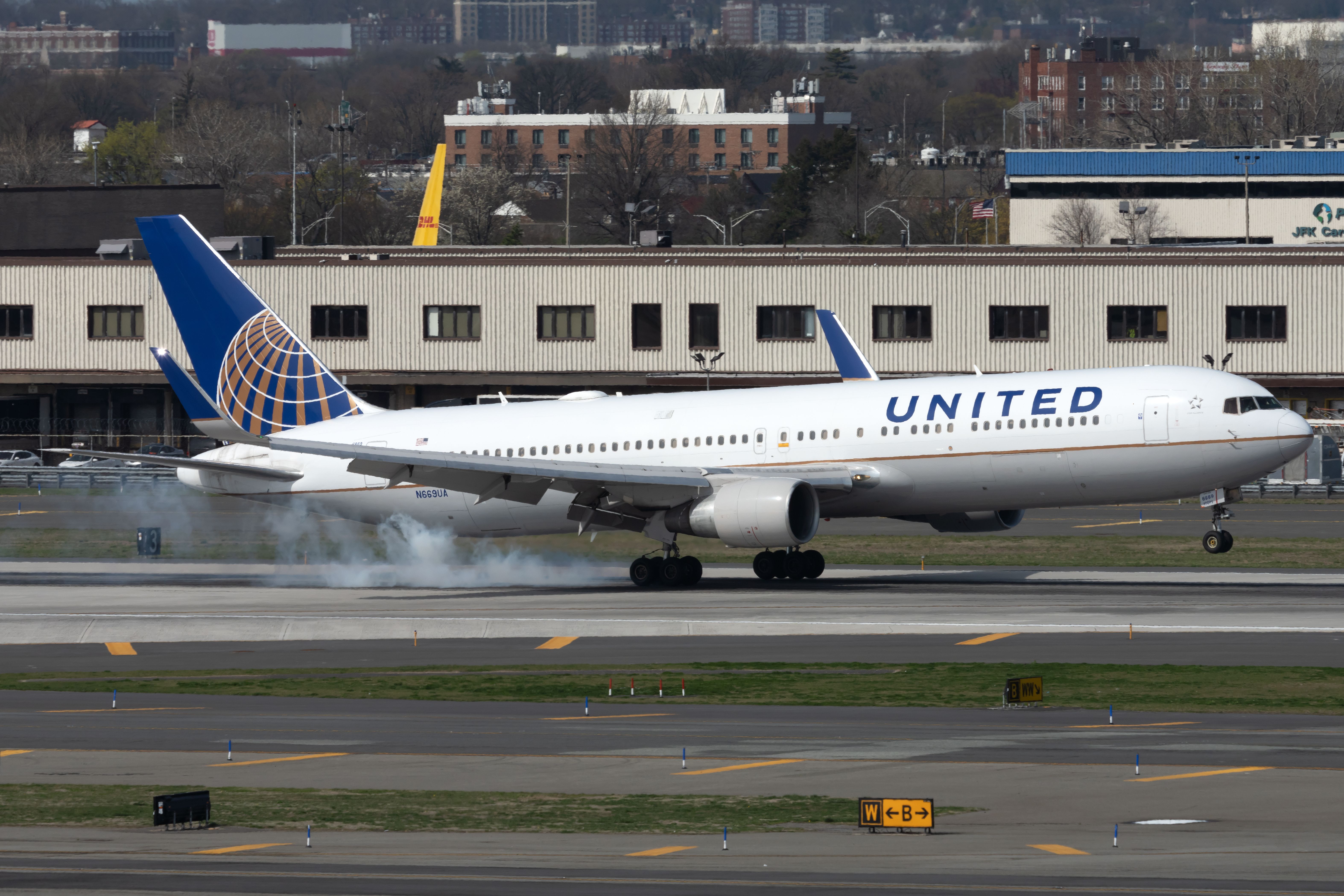 A United Airlines Boeing 767-322(ER) landing on a runway.