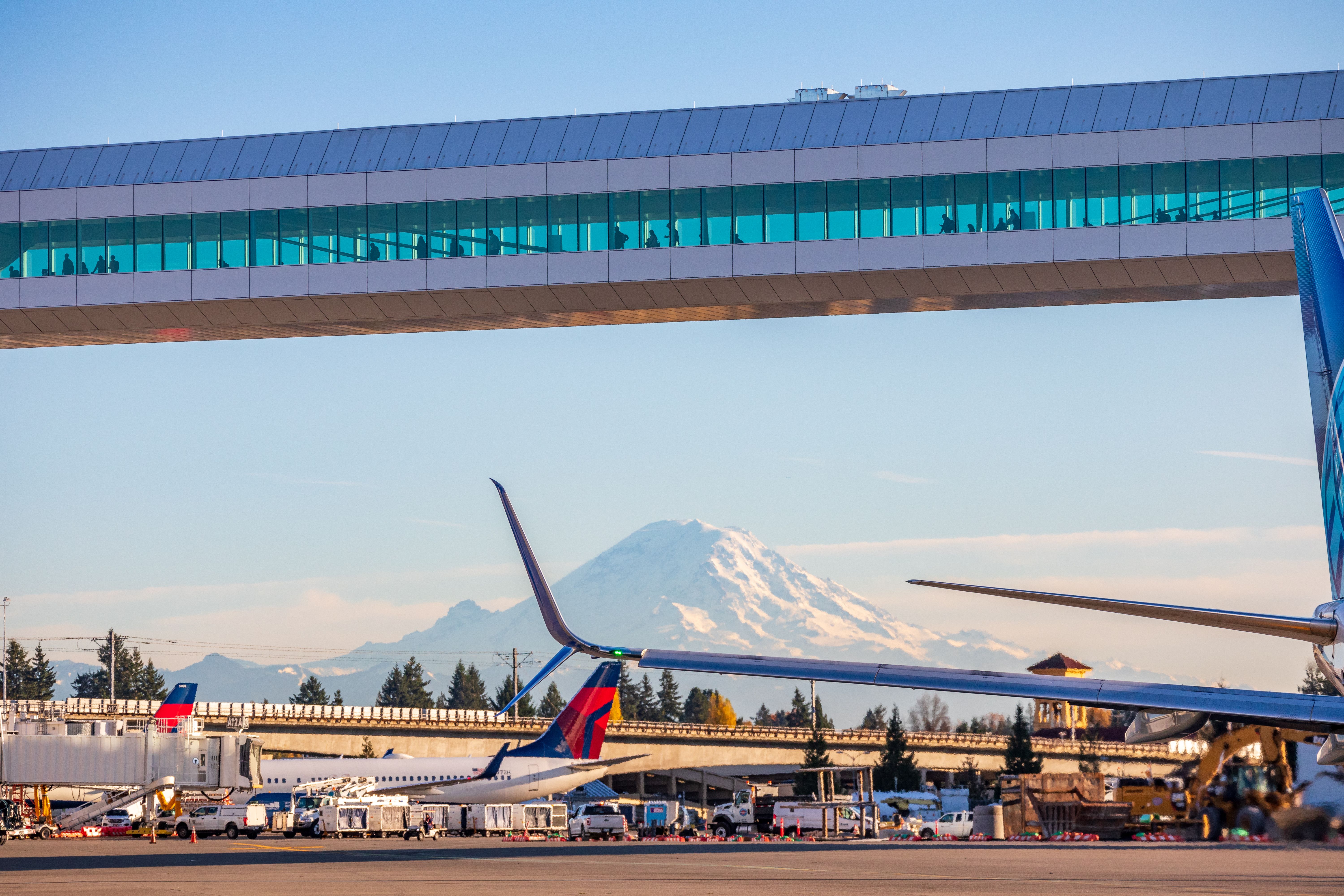 A view from the apron at Seattle Tacoma International Airport looking towards a mountain.