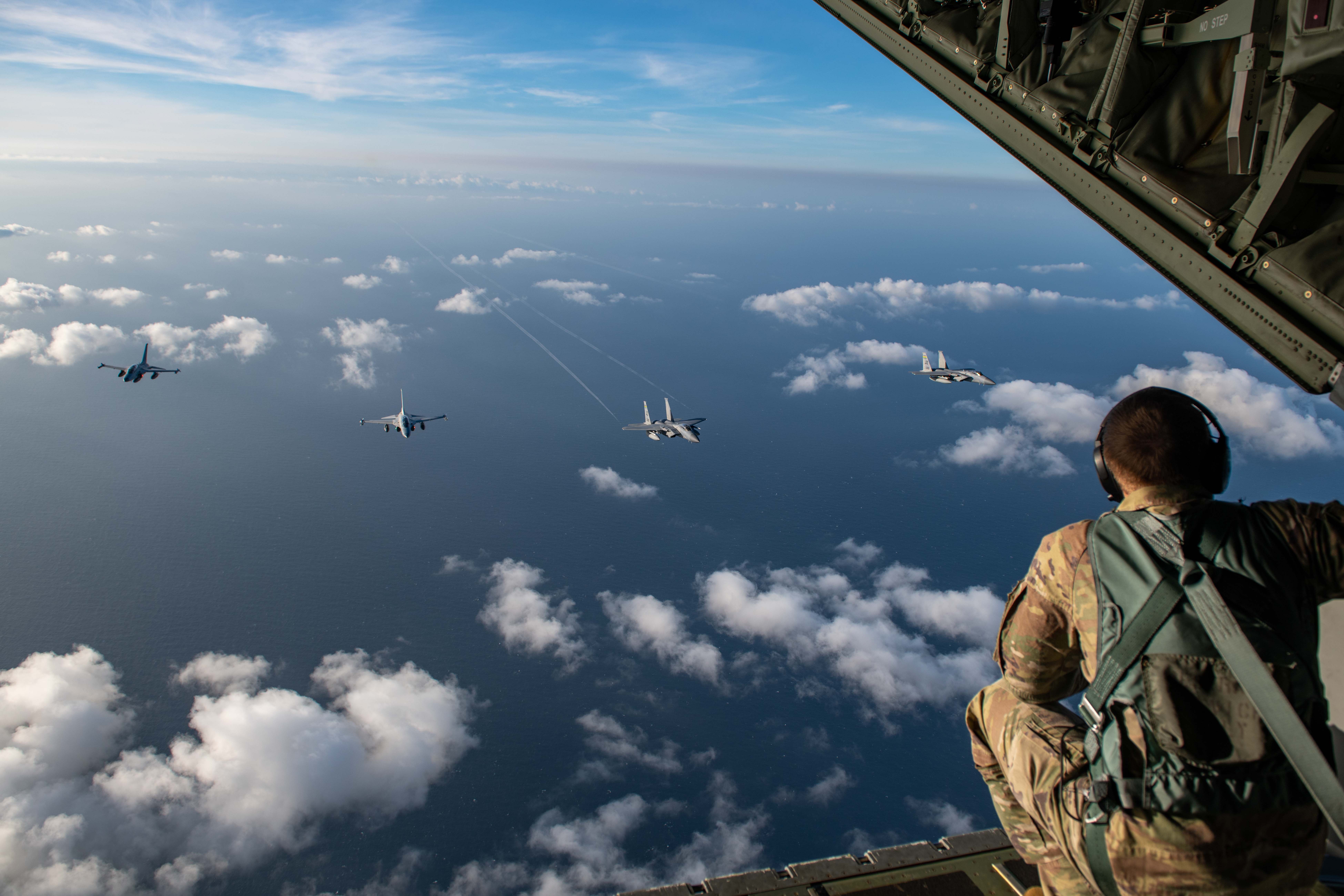 Two Philippine Air Force FA-50 Fighting Eagles fly alongside two U.S. Air Force F-15C Eagles over the South China Sea.