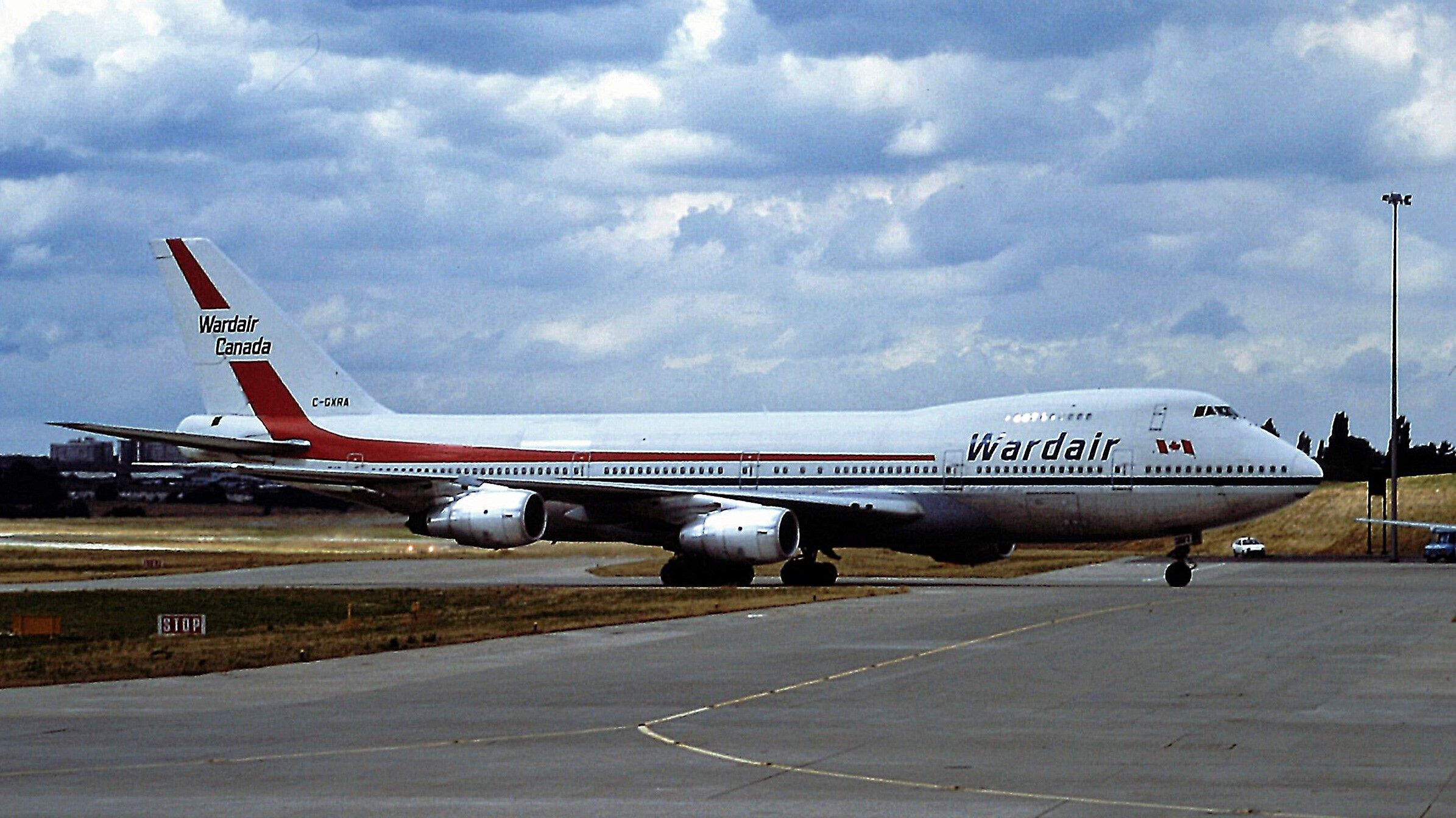 A Wardair Boeing 747-200 on an airport apron.