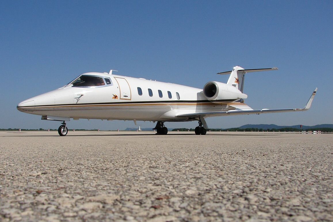 A Learjet 60 parked on an airport apron.
