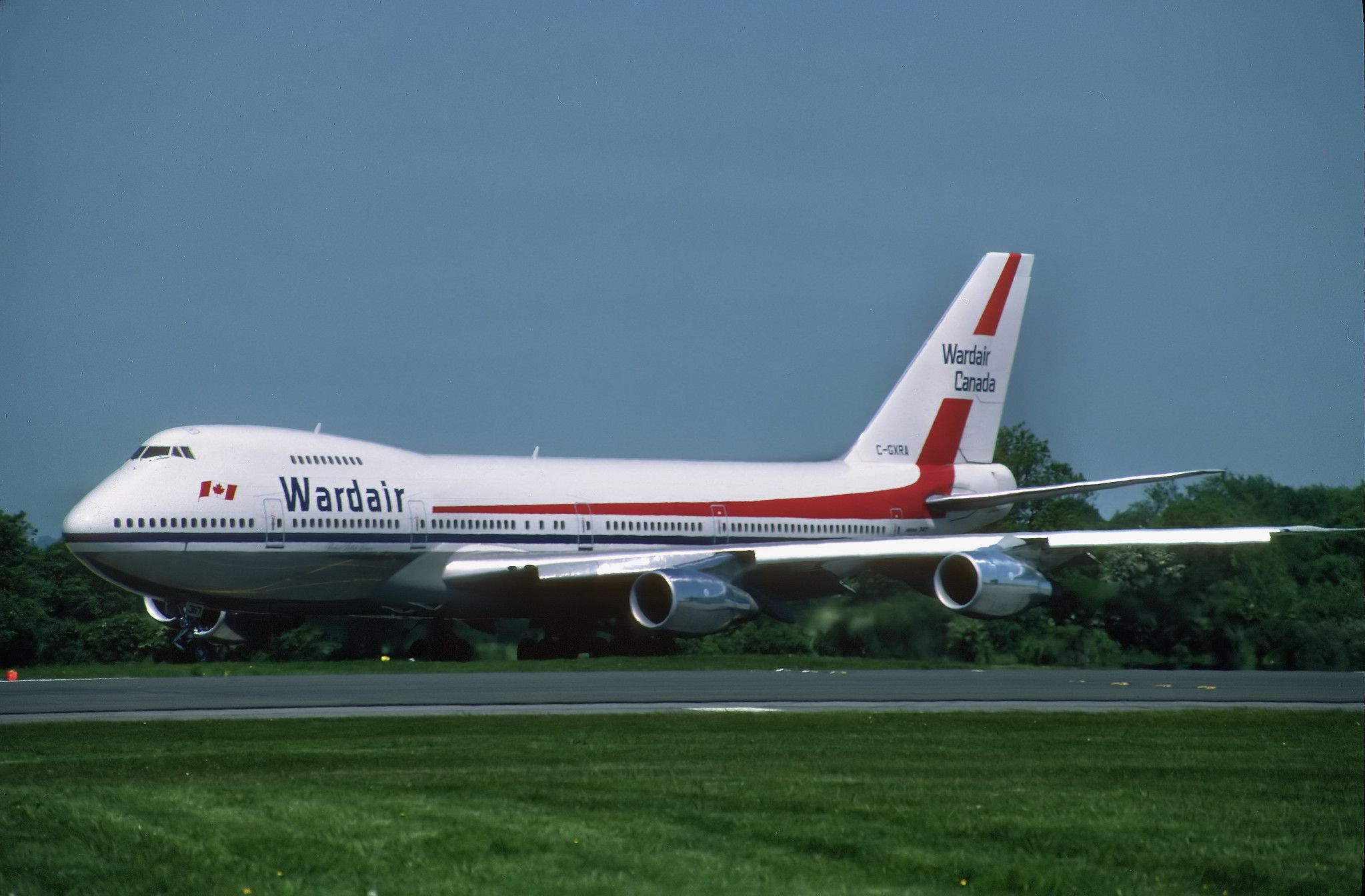 A Wardair Boeing 747-200 on an airport apron.