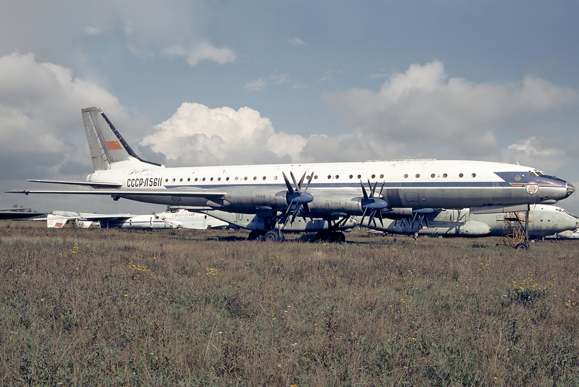 An Aeroflot Tupolev Tu-114 sitting in a field.