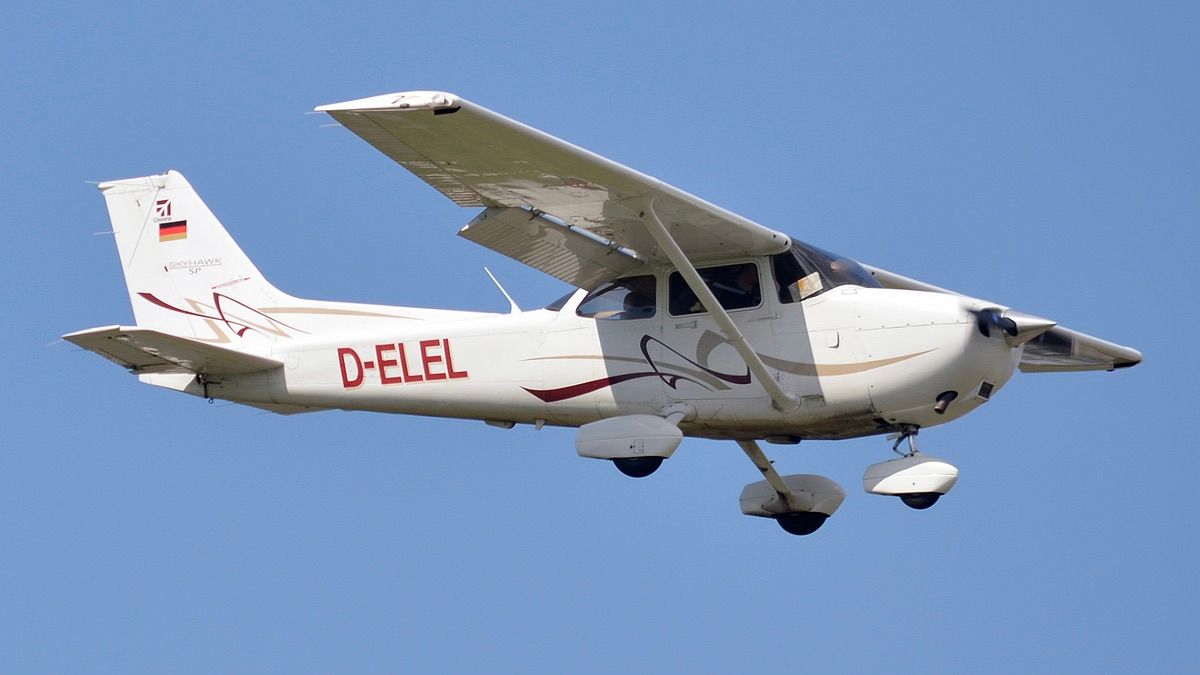 A Cessna 172 flying in the sky.