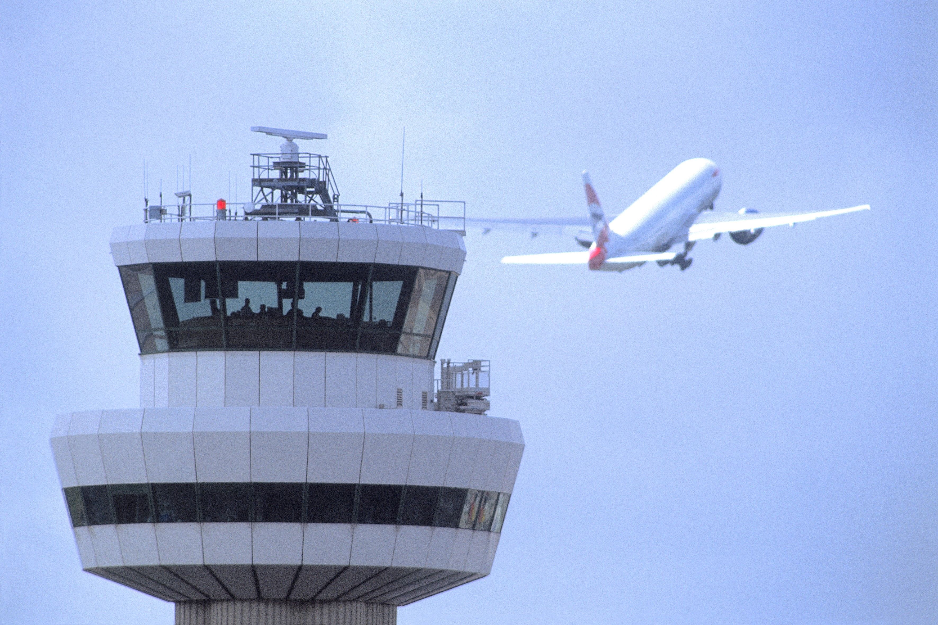 London Gatwick Airport ATC Tower With Plane Departing In The Background