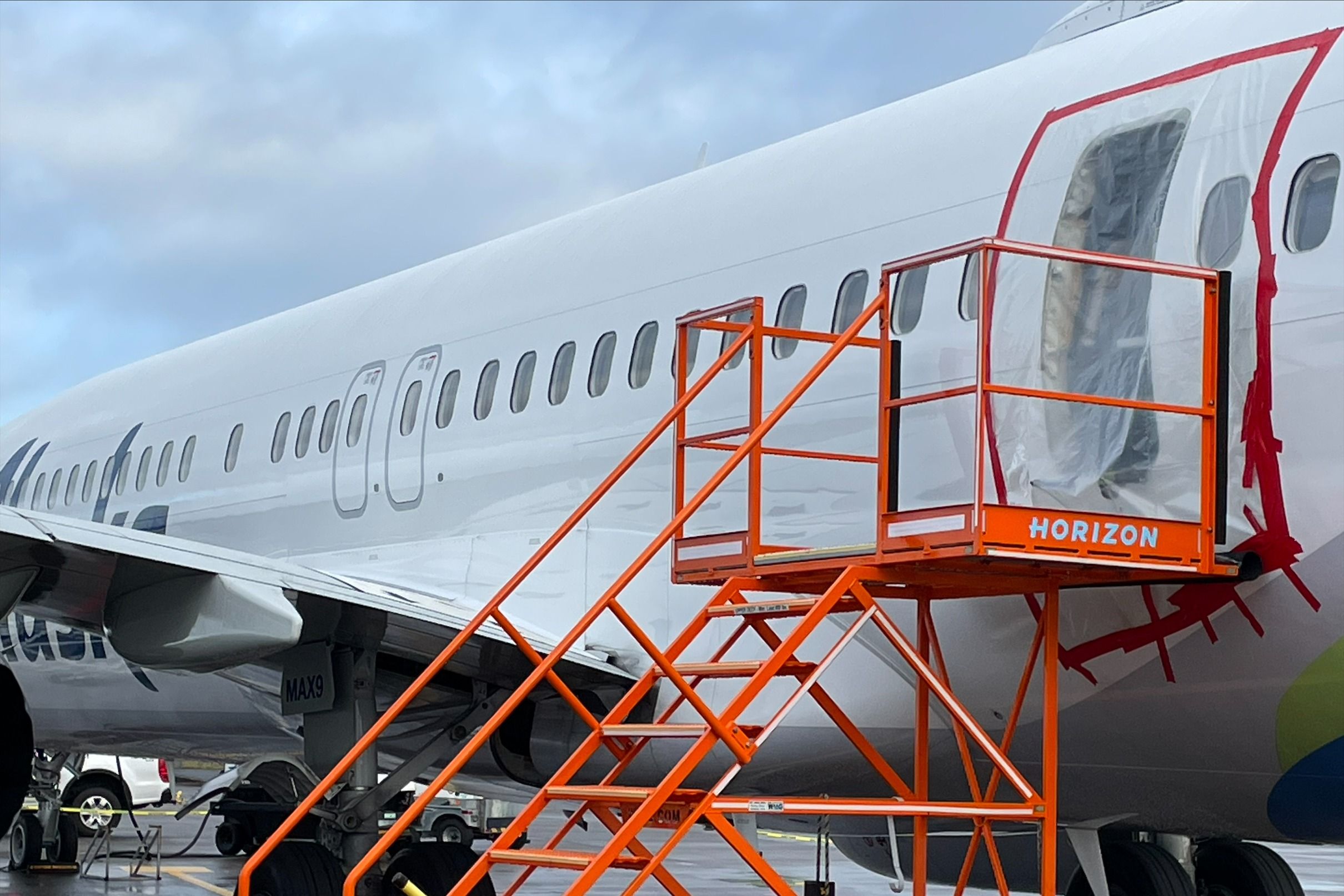 An Alaska Airlines Boeing 737 MAX 9 with a blown out door plug.