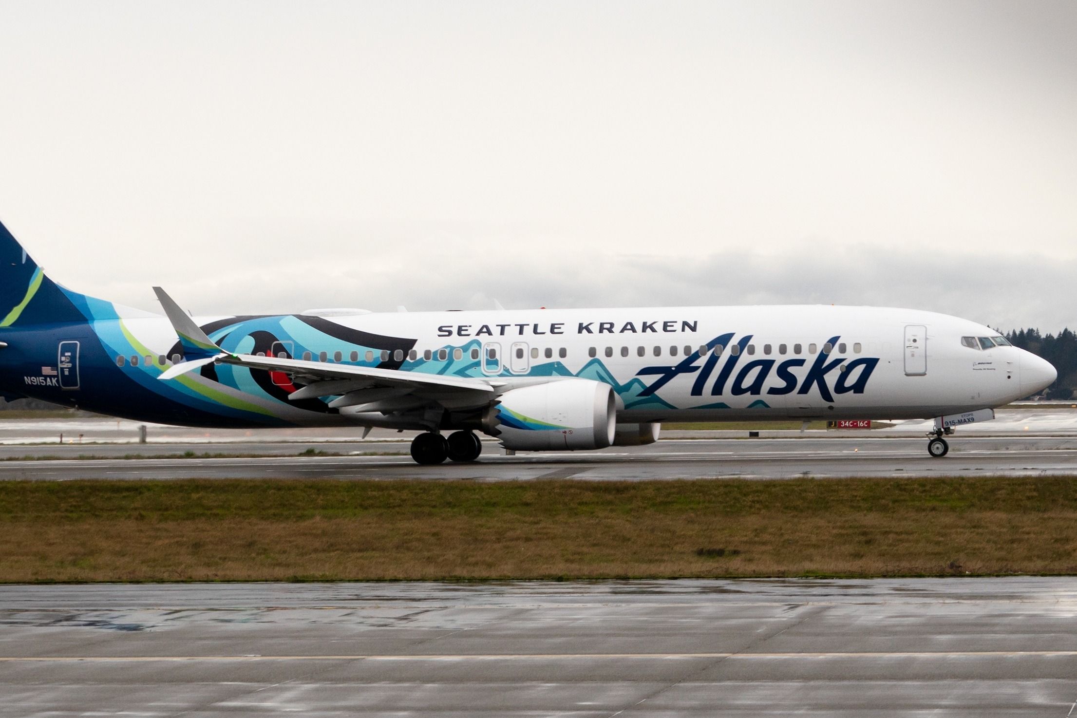 An Alaska Airlines Boeing 737 MAX 9 in Seattle Kraken livery on the apron at Seattle Tacoma International Airport.