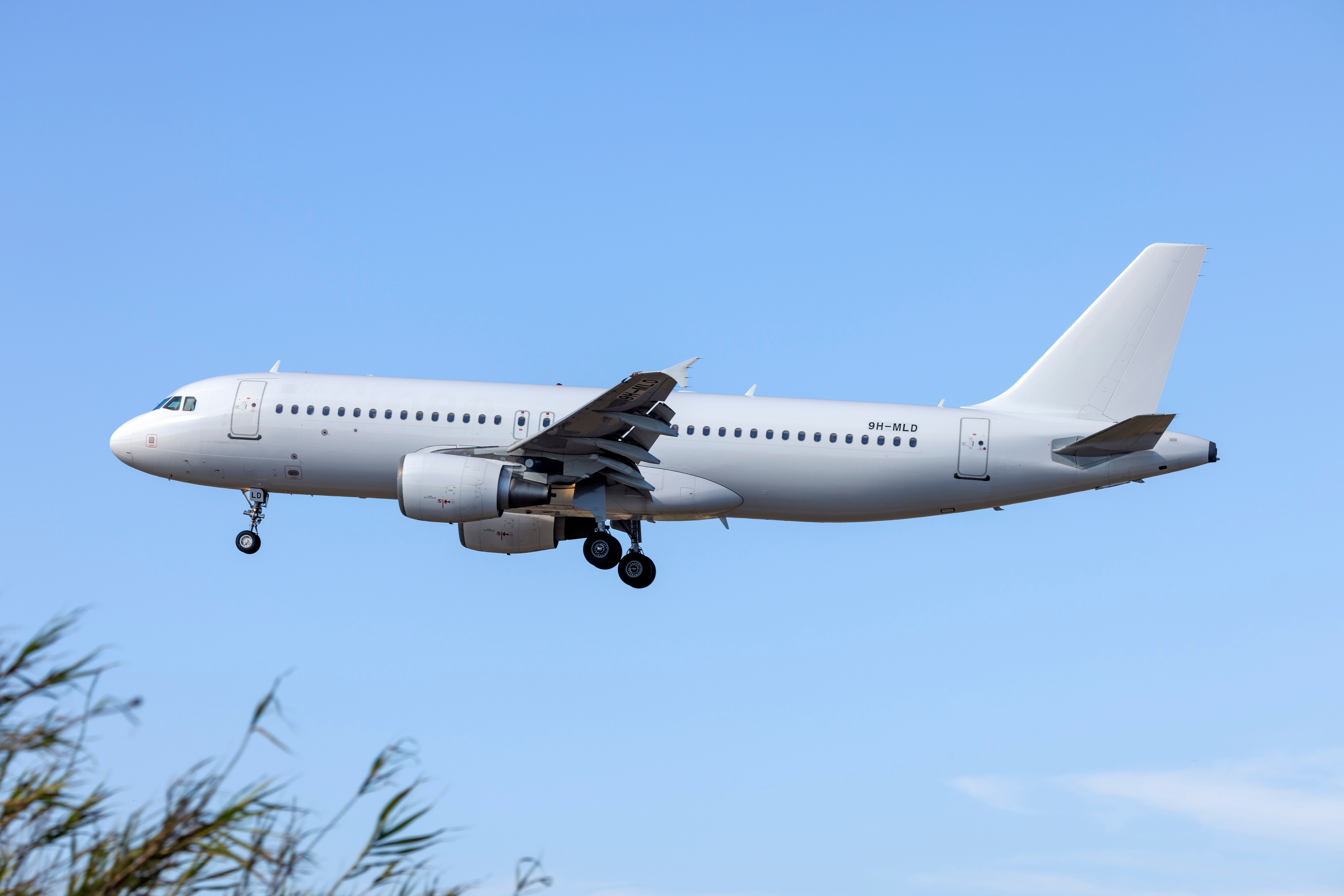 Avion Express Airbus A320 landing at Malta Luqa Internationl Airport MLA shutterstock_2327814165