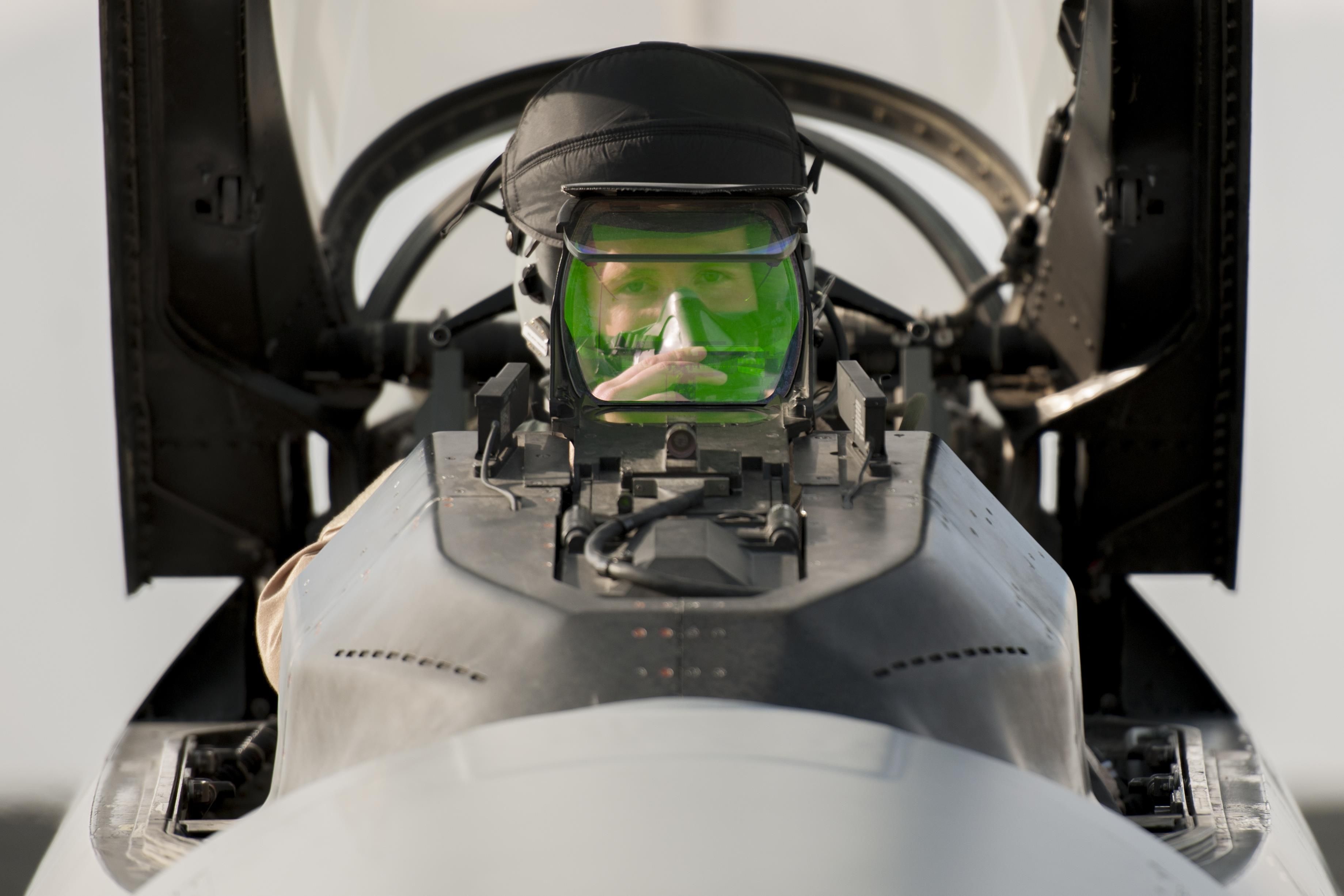 A pilot in an F-16 looking at the HUD.