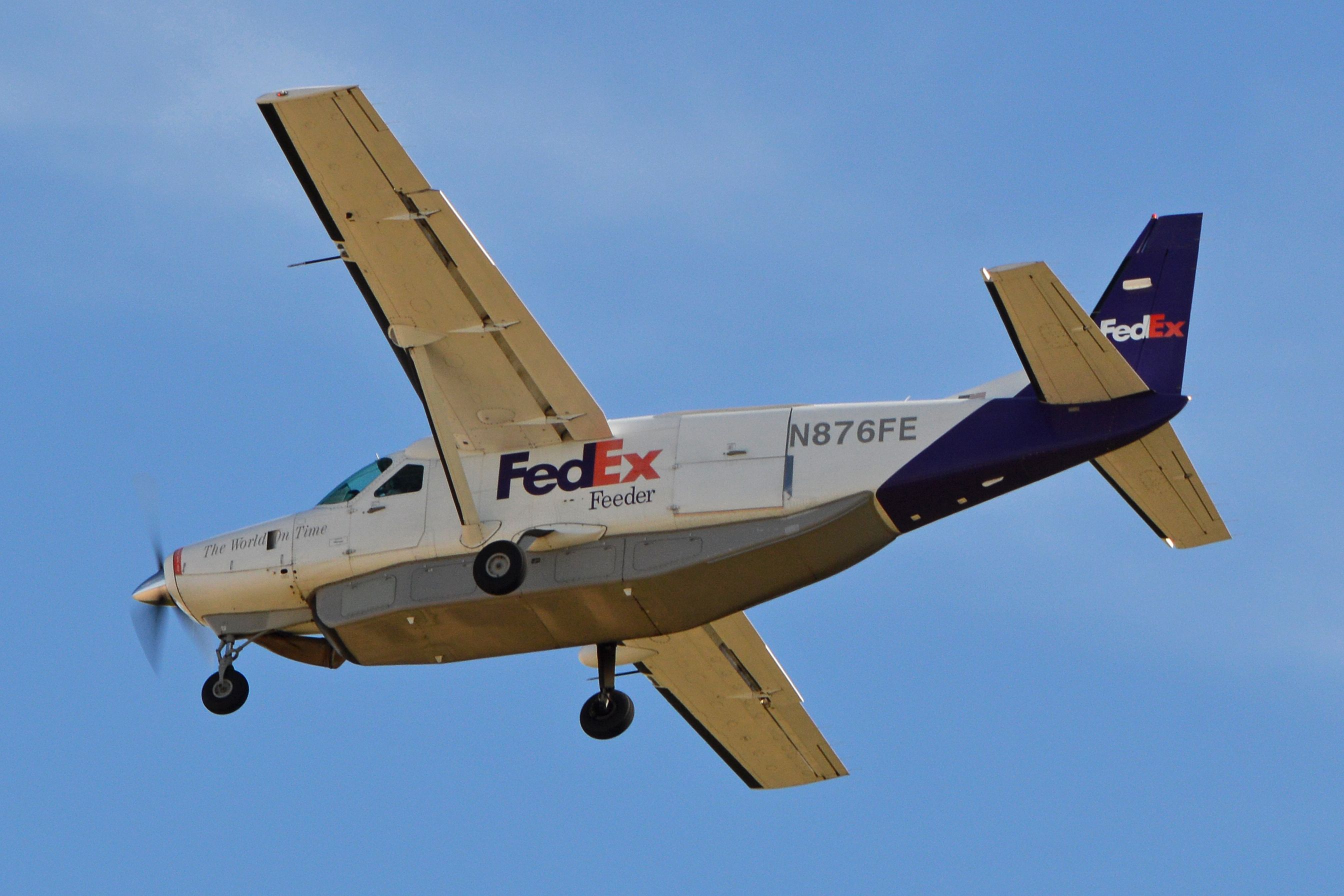 A FedEx Cessna 208 Flying in the sky.
