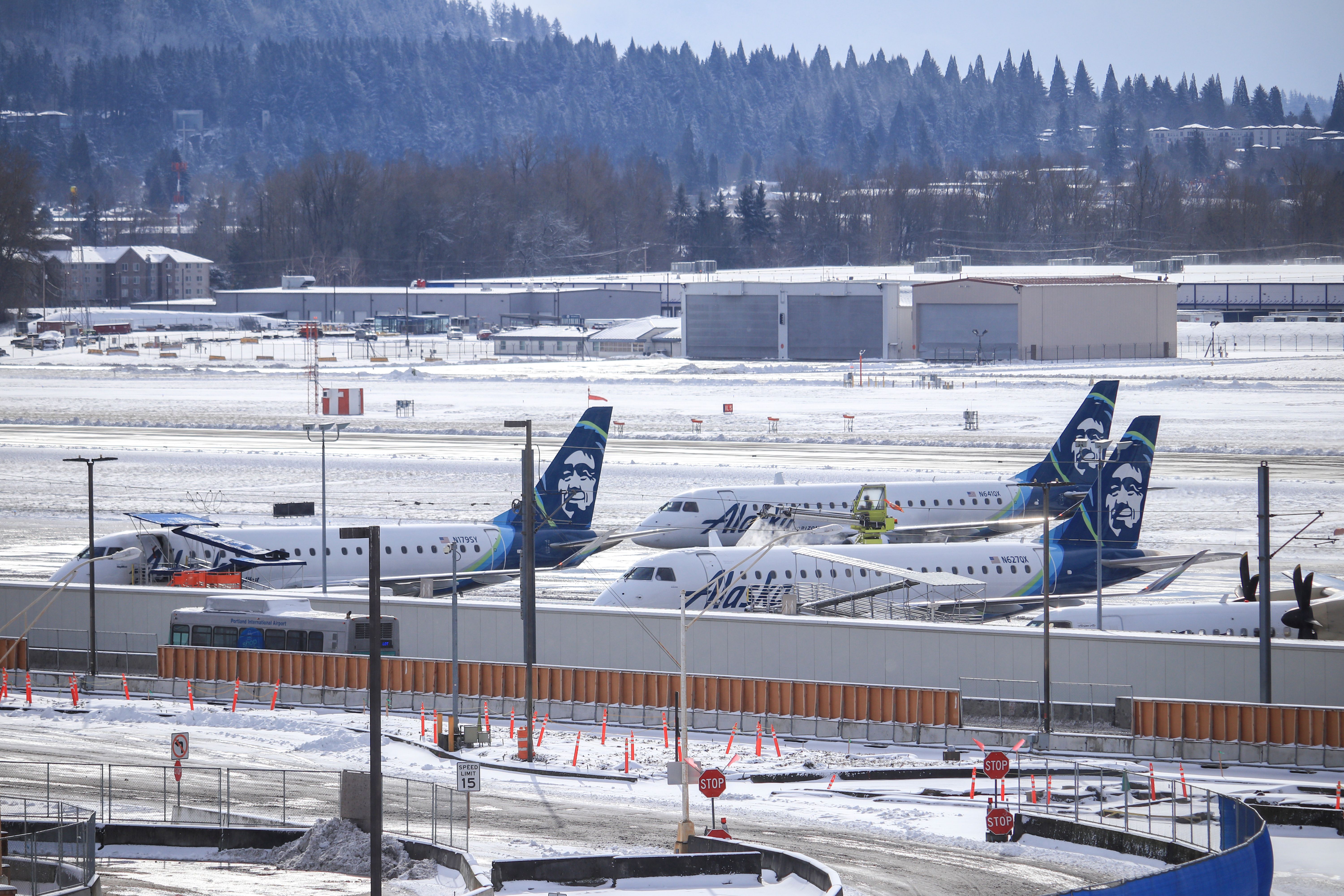 Three Alaska Airlines/Horizon Air aircraft on the apron at Portland International Airport.