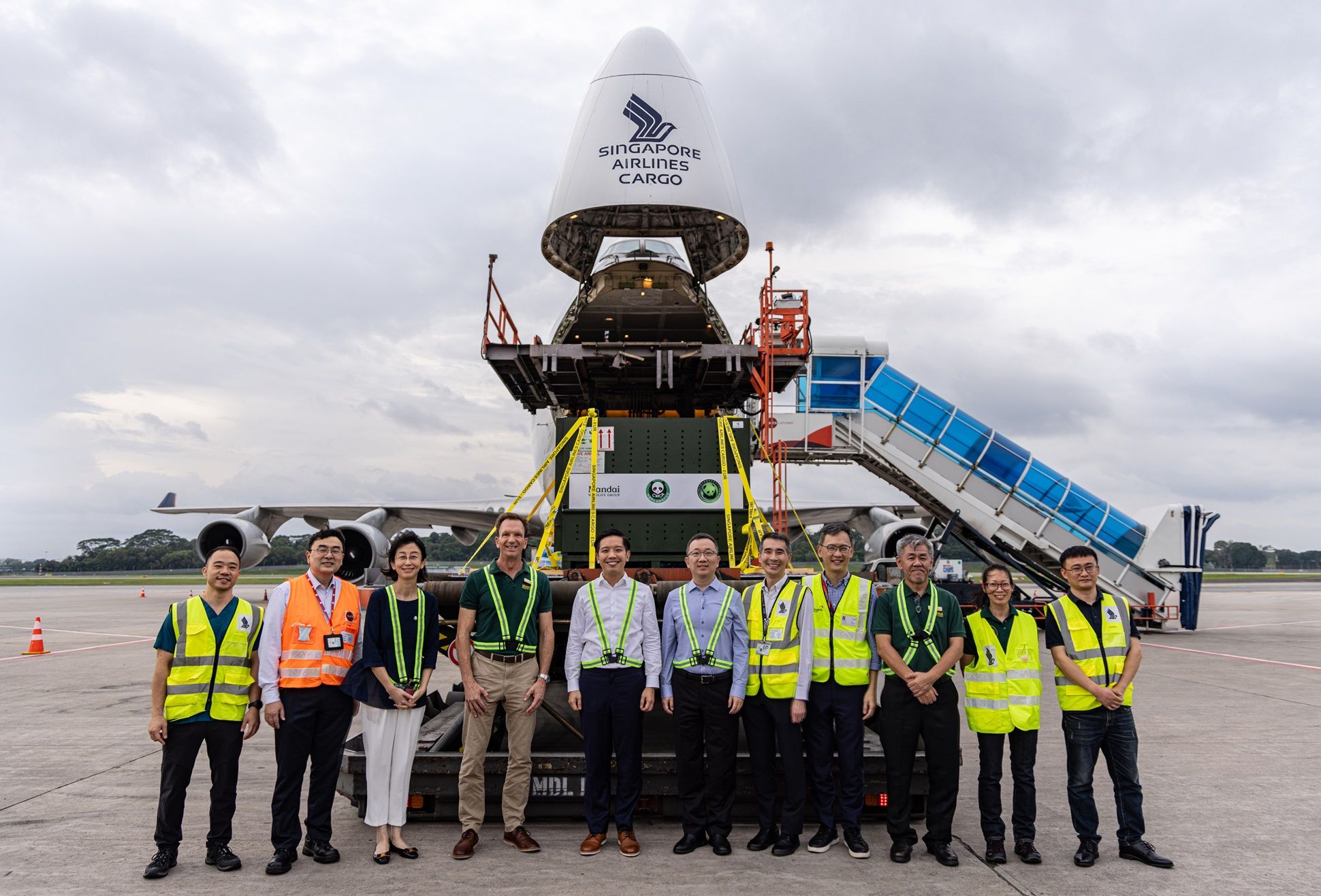 Singapore Airlines cargo team in front of an open Boeing 747-400F