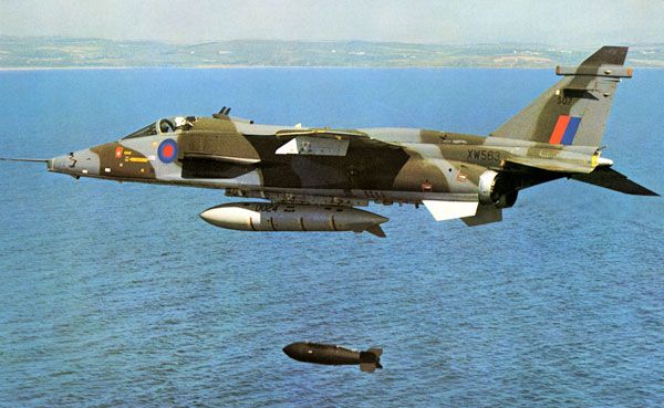 An RAF SEPECAT Jaguar dropping a bomb over water.