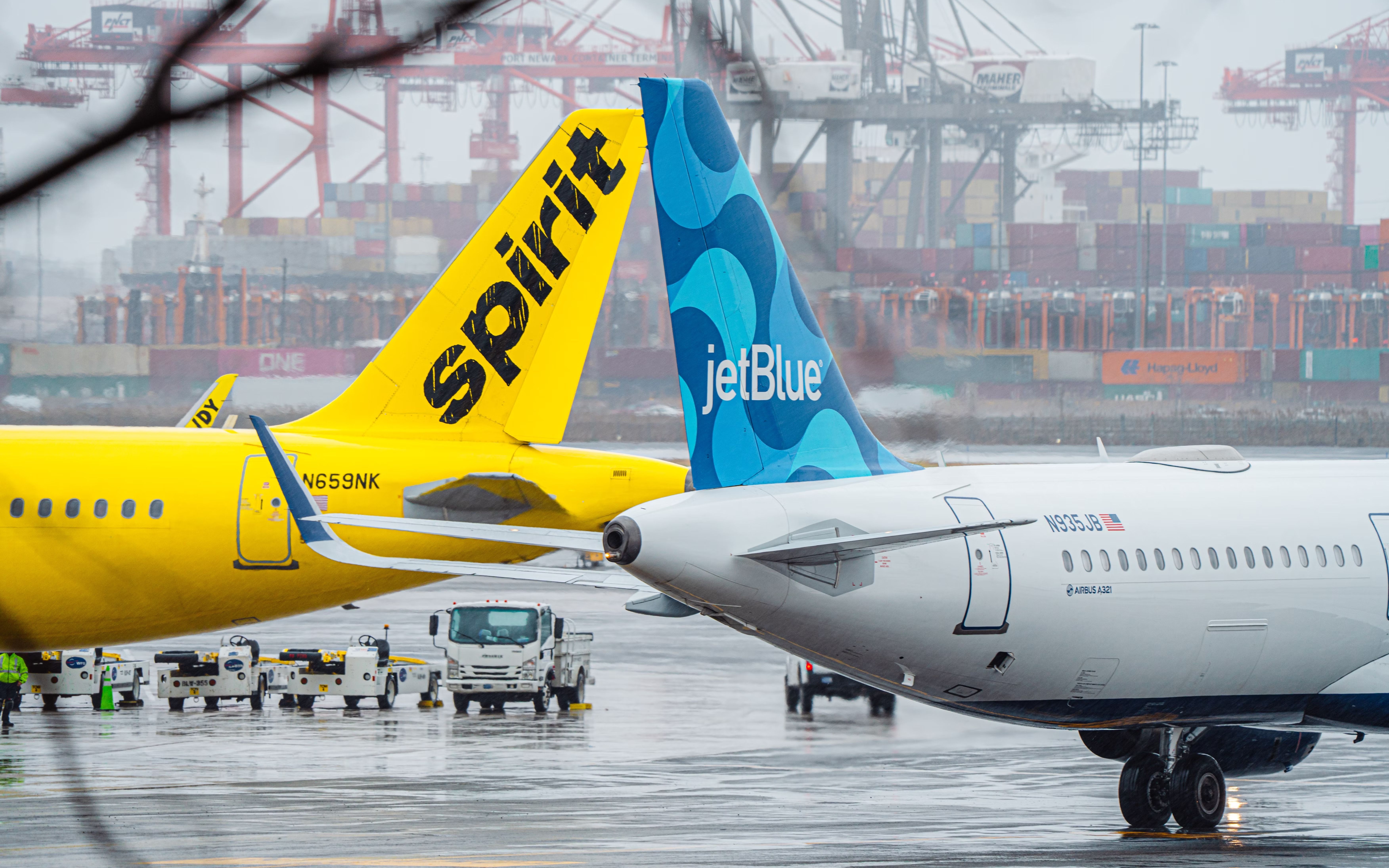 JetBlue and Spirit Airbus Aircraft side by side on an airport apron.