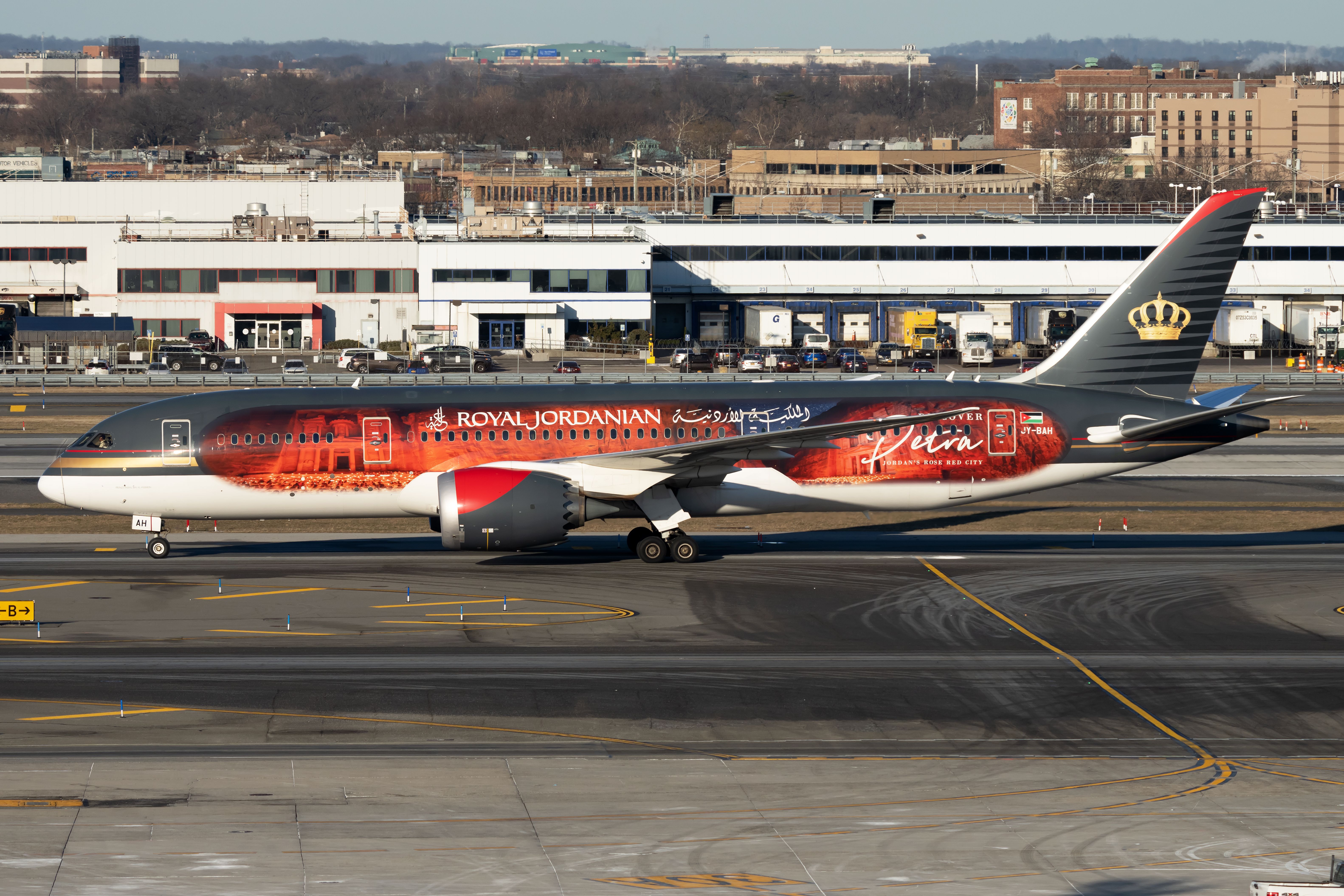 A Royal Jordanian Boeing 787 painted with a special livery on an airport apron.