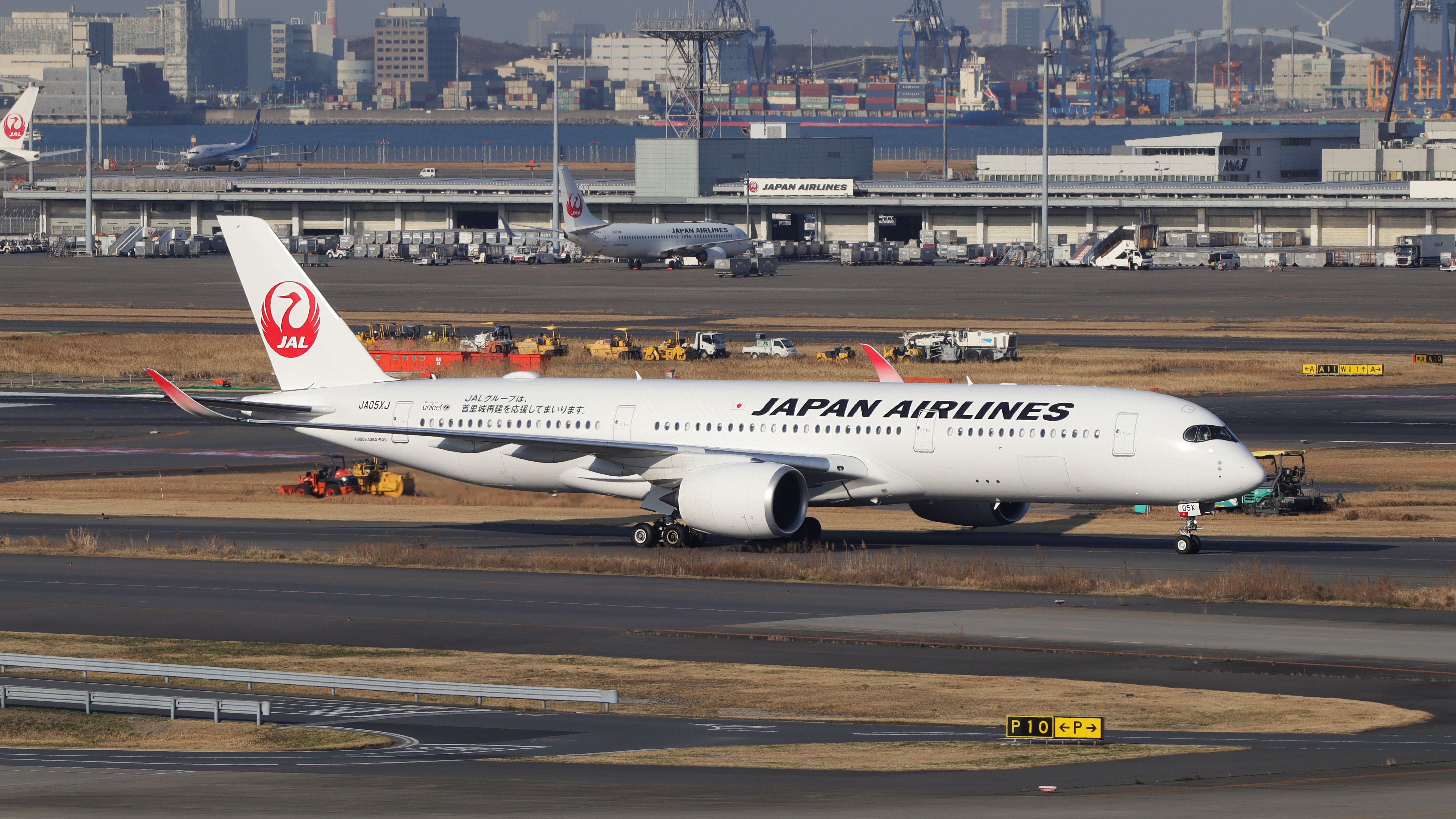 A Japan Airlines Airbus A350-900 on an airport apron.